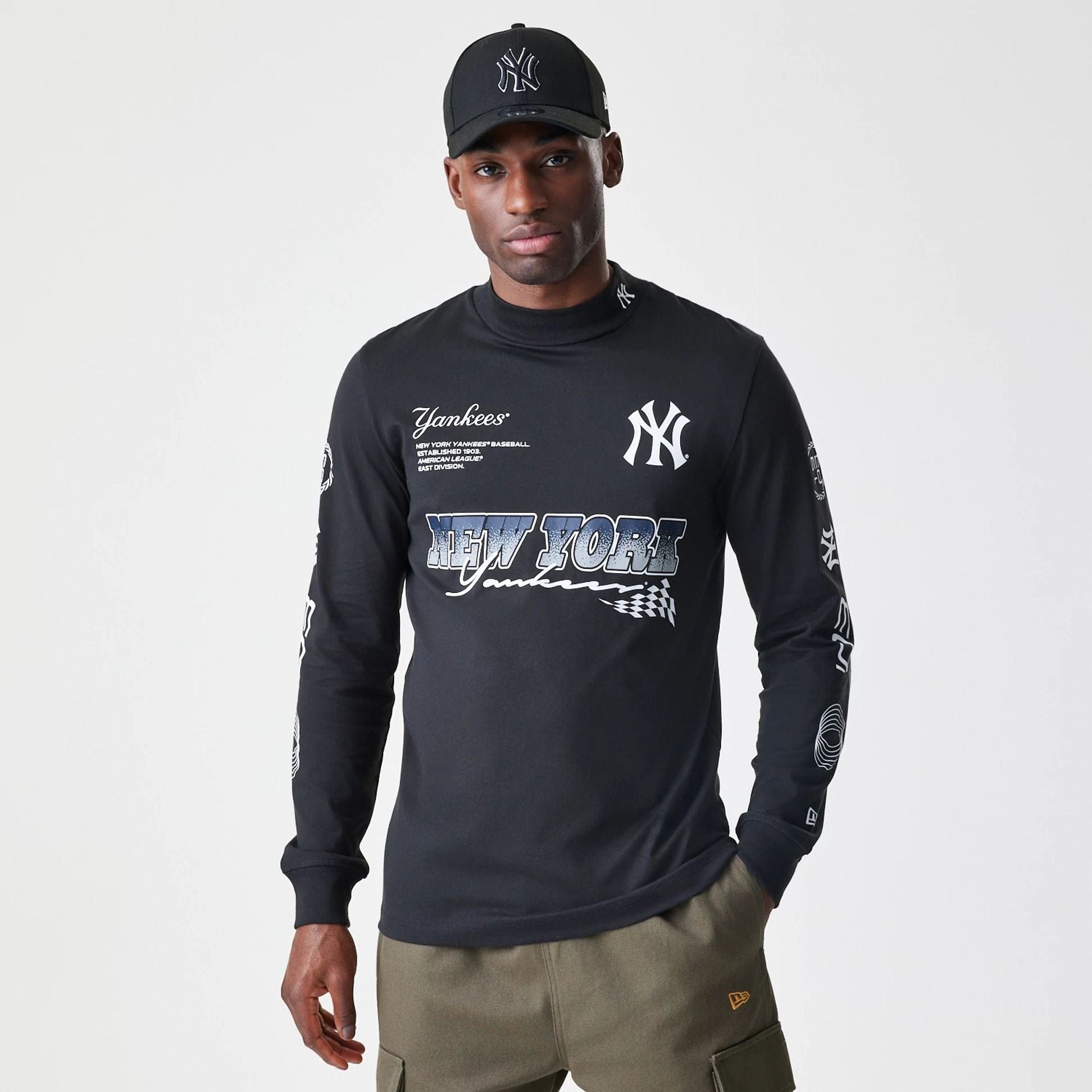The Male model is wearing New York Yankees Modern Driver Black Long Sleeve T-Shirt 1