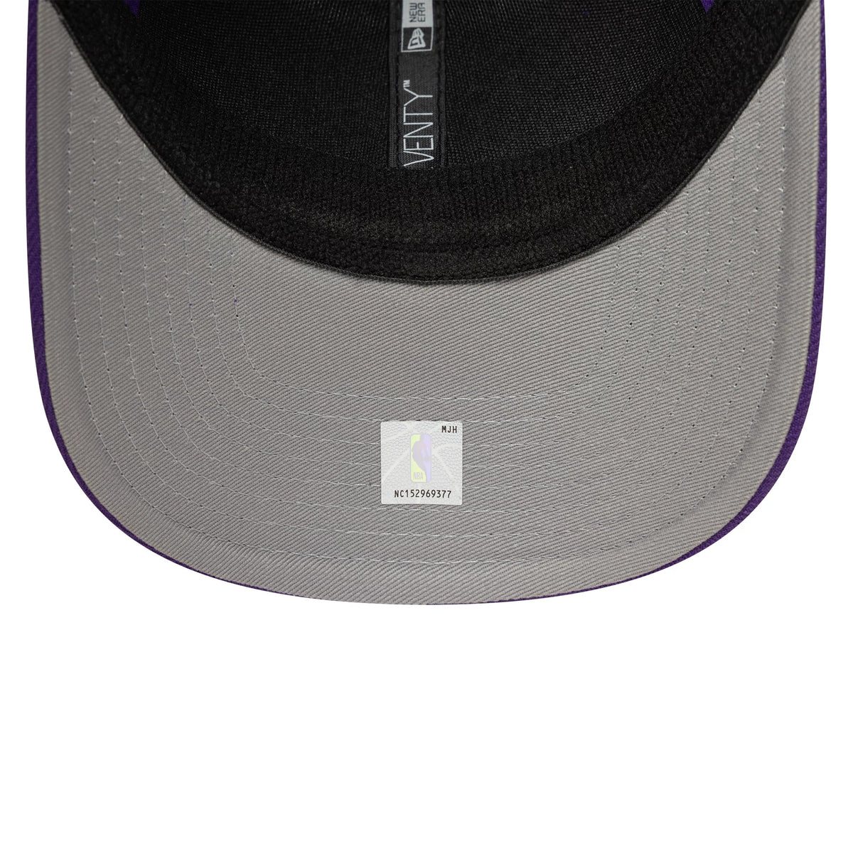 LA Lakers NBA Evergreen Purple New Era 9SEVENTY Stretch Snap Adjustable Cap, inside view showing black fabric taping with 9SEVENTY branding, a black sweatband, and a small white sticker on the grey undervisor.