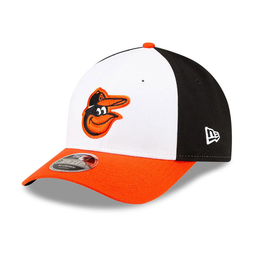 Baltimore Orioles MLB Player Replica White New Era 9FORTY M-Crown Adjustable Cap, three-quarter view showing the orange embroidered Orioles logo on the front panel, an orange visor with a 9FORTY size sticker, and New Era flag logo on the left side.