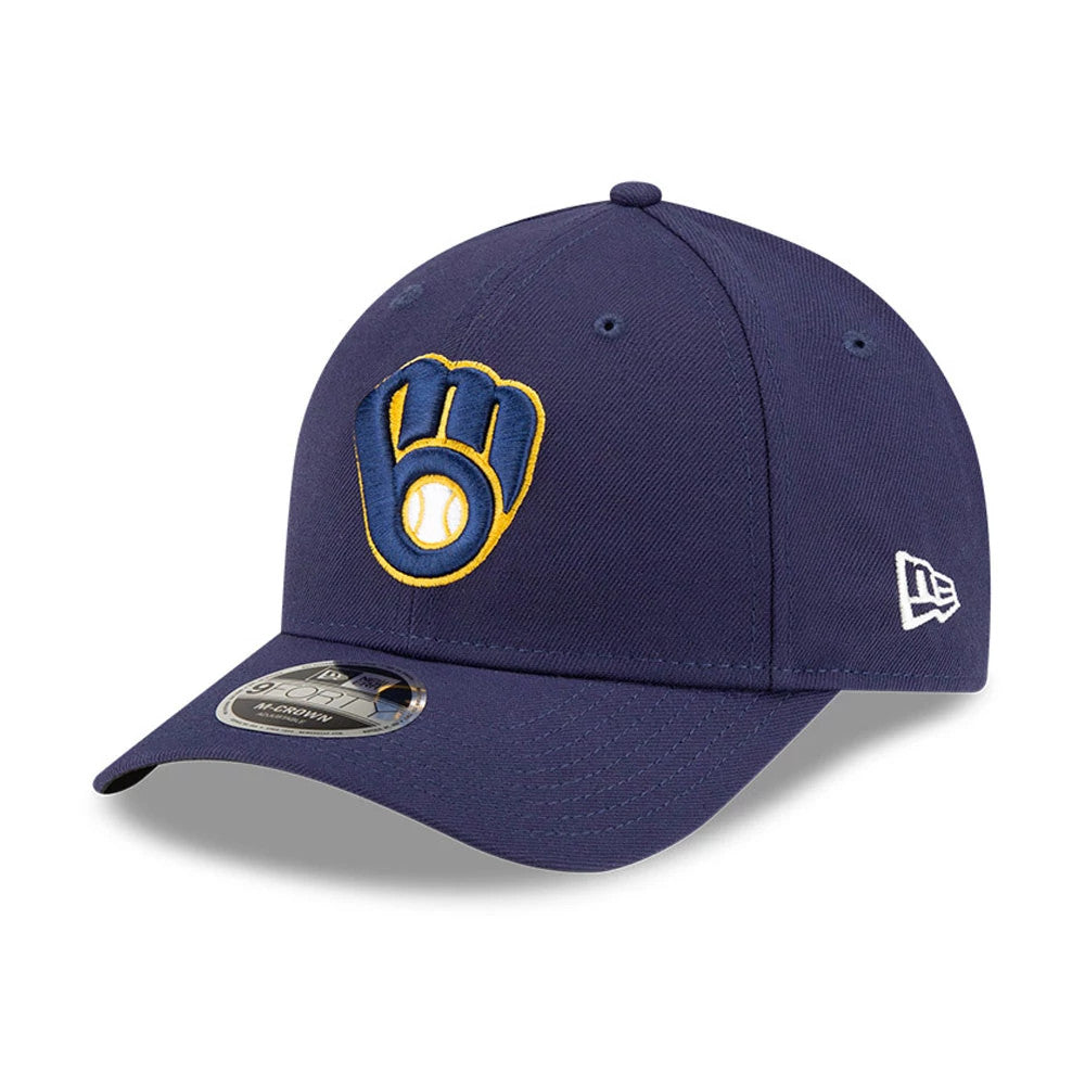 Milwaukee Brewers MLB Player Replica Navy New Era 9FORTY M-Crown Adjustable Cap, three-quarter view showing the raised yellow and blue embroidered glove logo on the front panel, curved visor with 9FORTY size sticker, and New Era flag logo on the left side.