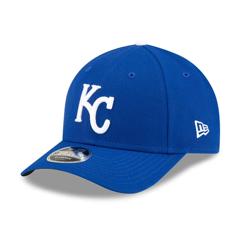 Kansas City Royals MLB Player Replica Blue New Era 9FORTY M-Crown Adjustable Cap, three-quarter view showing the white KC logo in raised embroidery on the front panel, with a New Era flag logo on the left side and a 9FORTY size sticker on the visor.