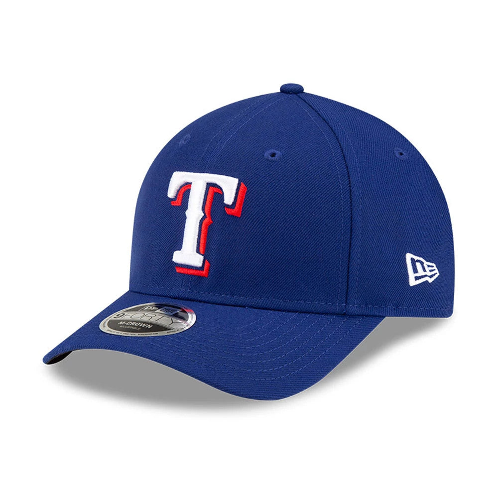 Texas Rangers MLB Player Replica Dark Blue New Era 9FORTY M-Crown Adjustable Cap, three-quarter view showing the raised embroidered T logo on the front panel, blue curved visor with 9FORTY size sticker, and New Era flag logo on the left side.