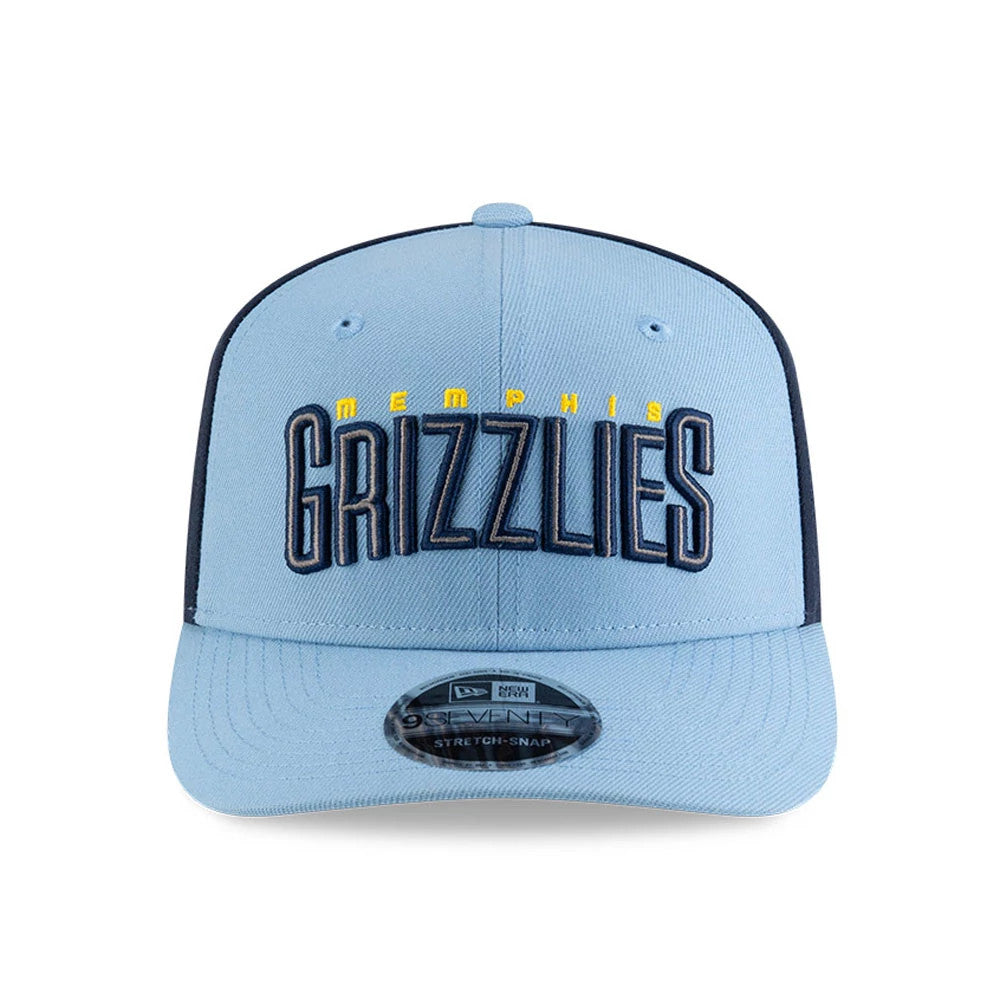 Memphis Grizzlies NBA Statement Pastel Blue New Era 9SEVENTY Stretch Snap Adjustable Cap, front view showing raised navy and yellow Grizzlies lettering on the pastel blue crown, with matching 9SEVENTY size sticker on the flat pastel blue visor.