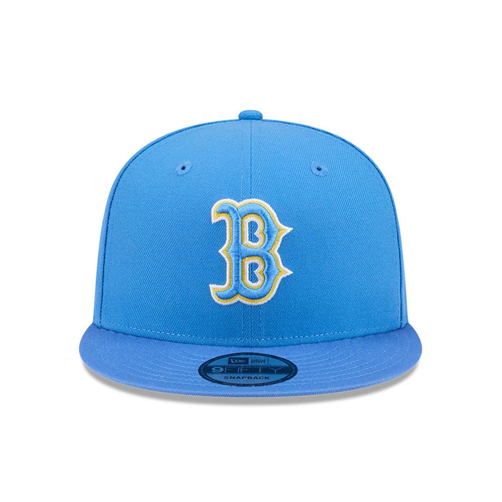 Boston Red Sox MLB Evergreen Blue New Era 9FIFTY Snapback Adjustable Cap, front view showing the yellow outlined B logo embroidered on the structured blue crown, flat blue visor, and 9FIFTY size sticker.