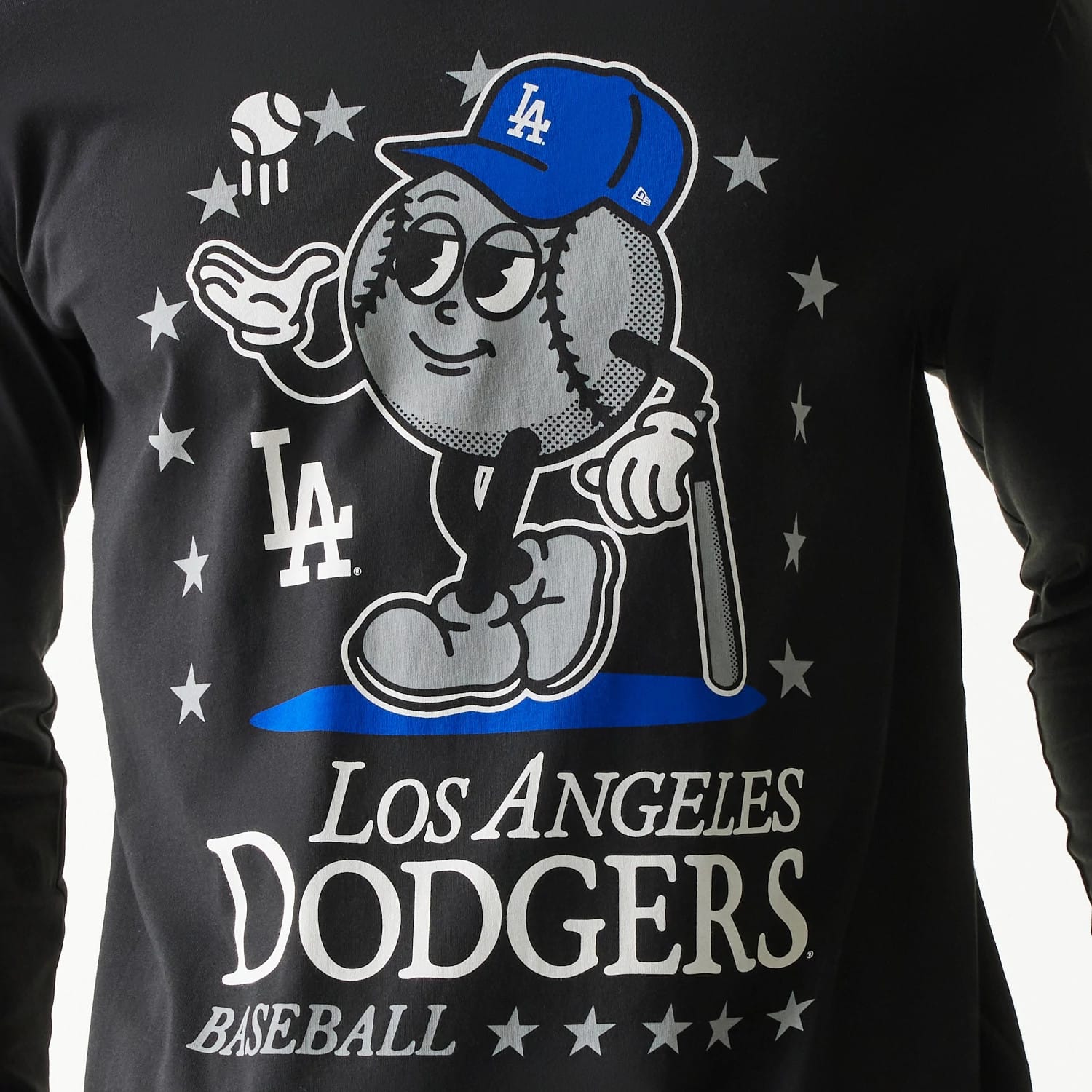 New Era LA Dodgers MLB Character Black Long Sleeve T-Shirt, front view showing a cartoon baseball character wearing a blue LA cap amid grey stars, with white LA Dodgers text and logo below on the black fabric.