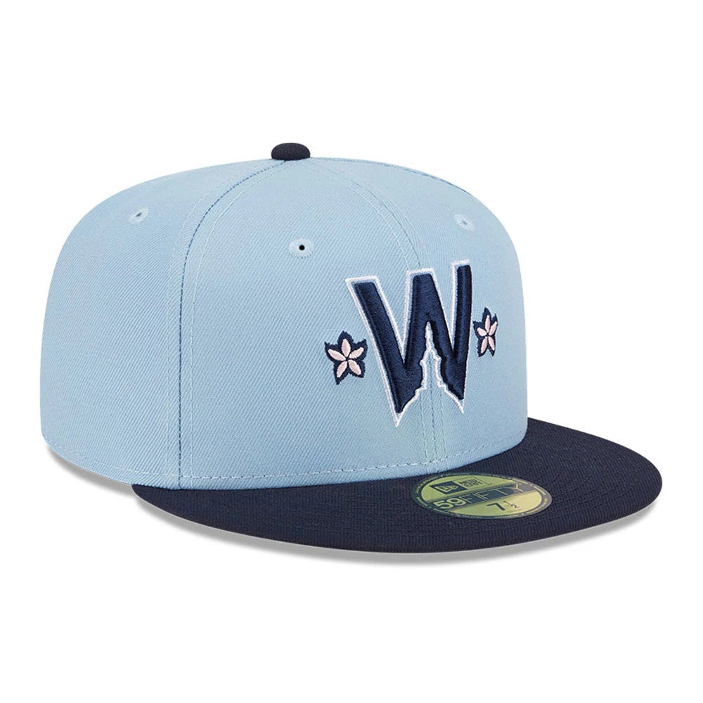 Washington Nationals MLB City Connect Light Blue New Era 59FIFTY Fitted Cap, front view showing the navy and white embroidered W logo with pink flower details on the light blue crown, a navy visor, and gold 59FIFTY size sticker.