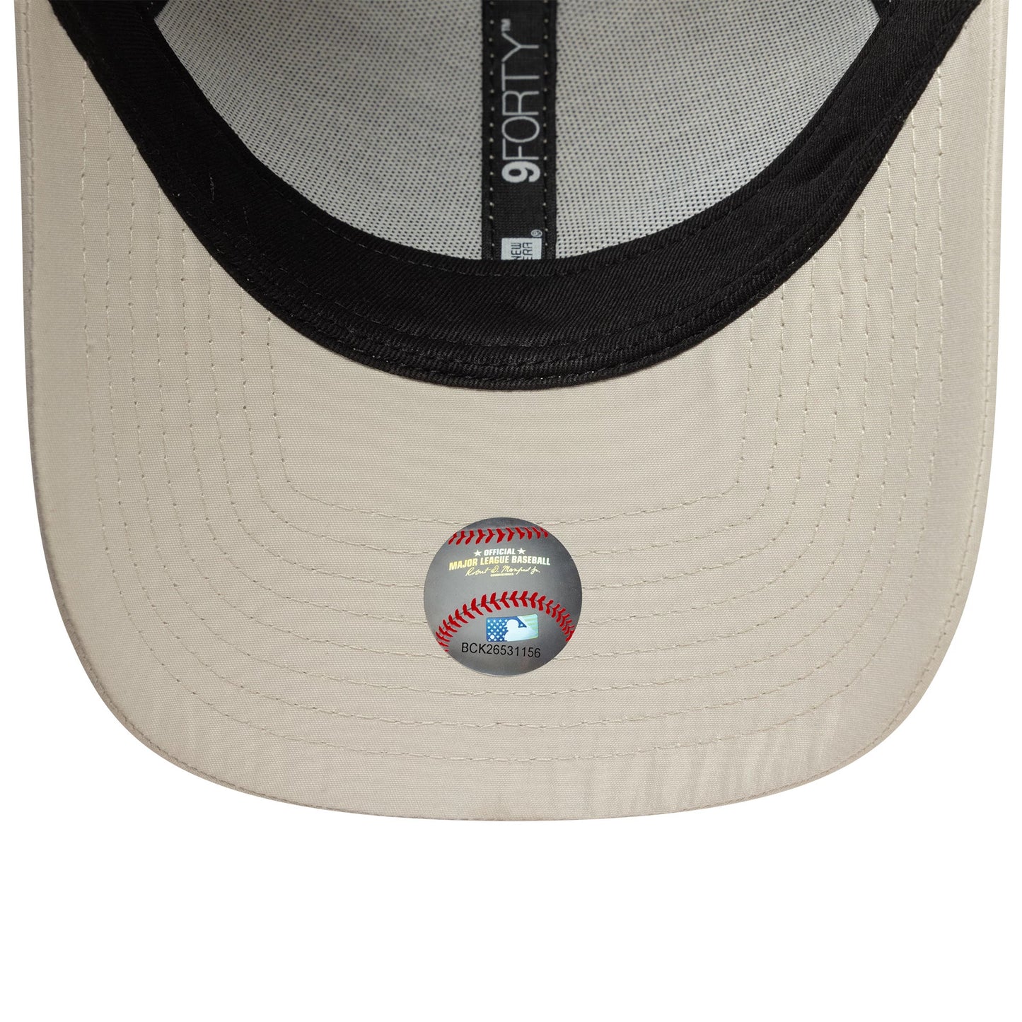 New York Yankees Tonal Flawless Cream New Era 9FORTY Adjustable Cap, inside view showing contrasting black undervisor, grey taping with 9FORTY label, and an MLB holographic sticker centred on the cream fabric.