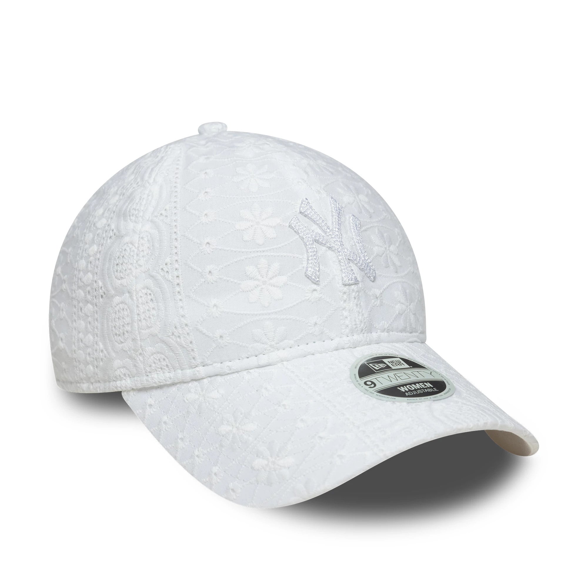 New York Yankees Womens MLB Broderie White New Era 9TWENTY Adjustable Cap, three-quarter view showing the white embroidered NY logo on the front panel, intricate broderie pattern across the crown, and 9TWENTY size sticker on the curved visor.