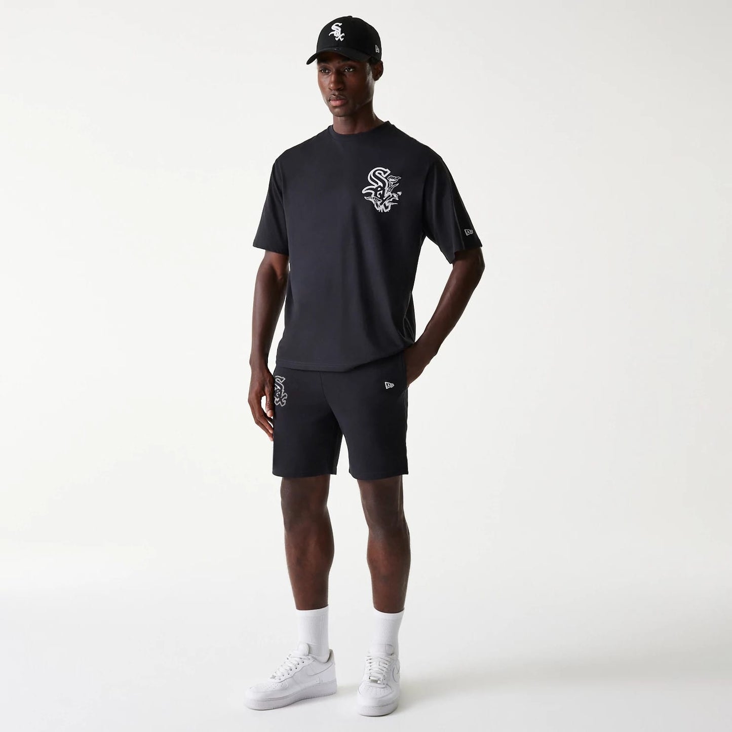 The Male model is wearing Chicago White Sox MLB League Essential Black Shorts 8