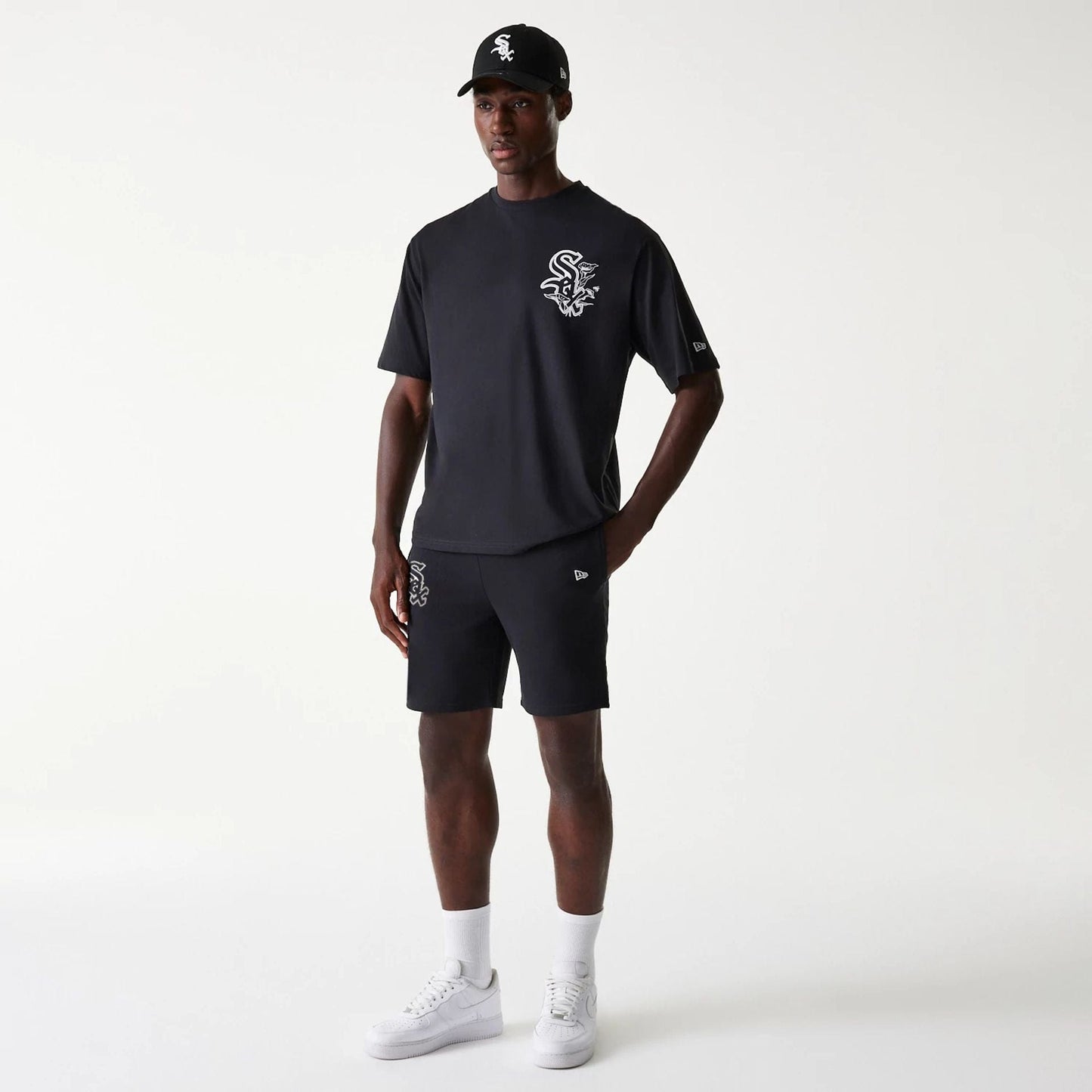 The Male model is wearing Chicago White Sox MLB League Essential Black Shorts 8
