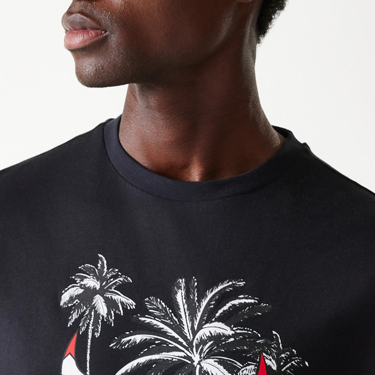 New Era Chicago Bulls NBA Palm Tree Black Oversized T-Shirt, front view showing a detailed palm tree graphic in white and red on the centre of the chest, with a round black neckline.