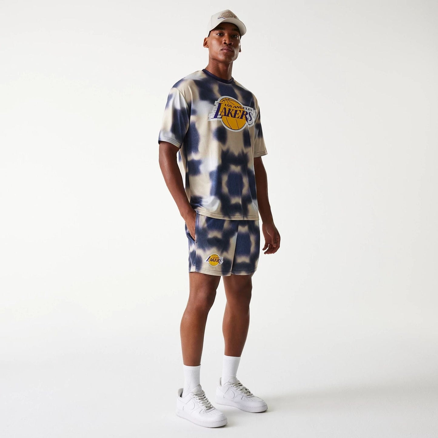 The Male model is wearing LA Lakers NBA All Over Print Cream Shorts 8