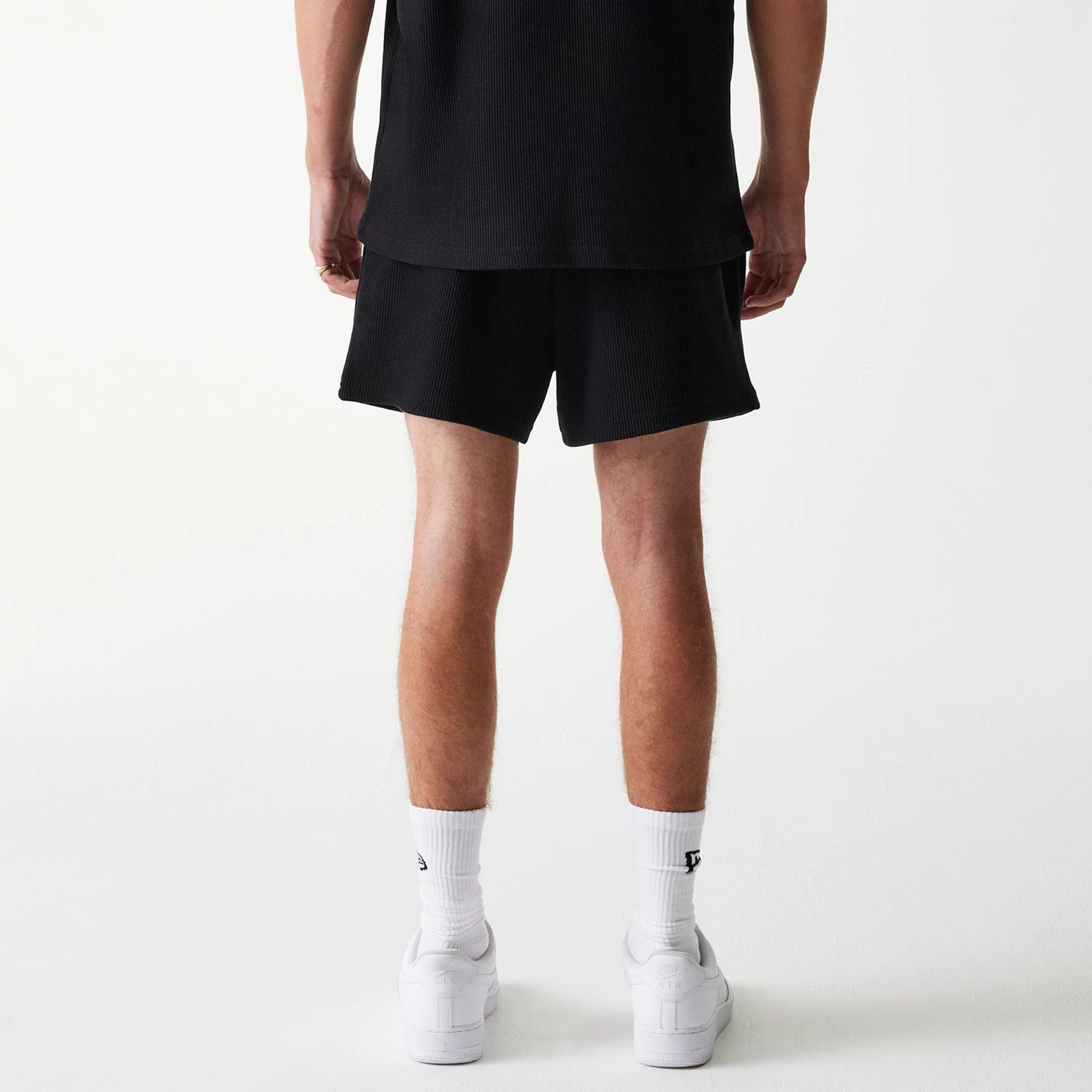 The Male model is wearing New Era Waffle Black Shorts 2