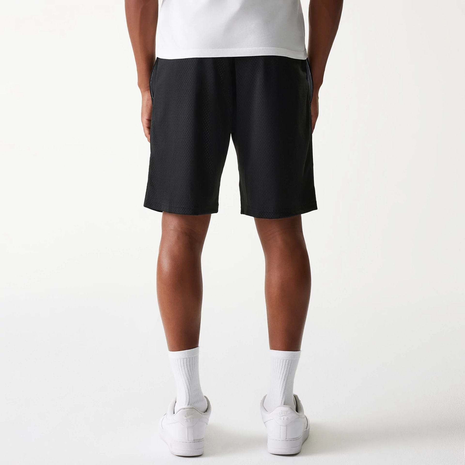 The Male model is wearing New Era Black Mesh Shorts 2
