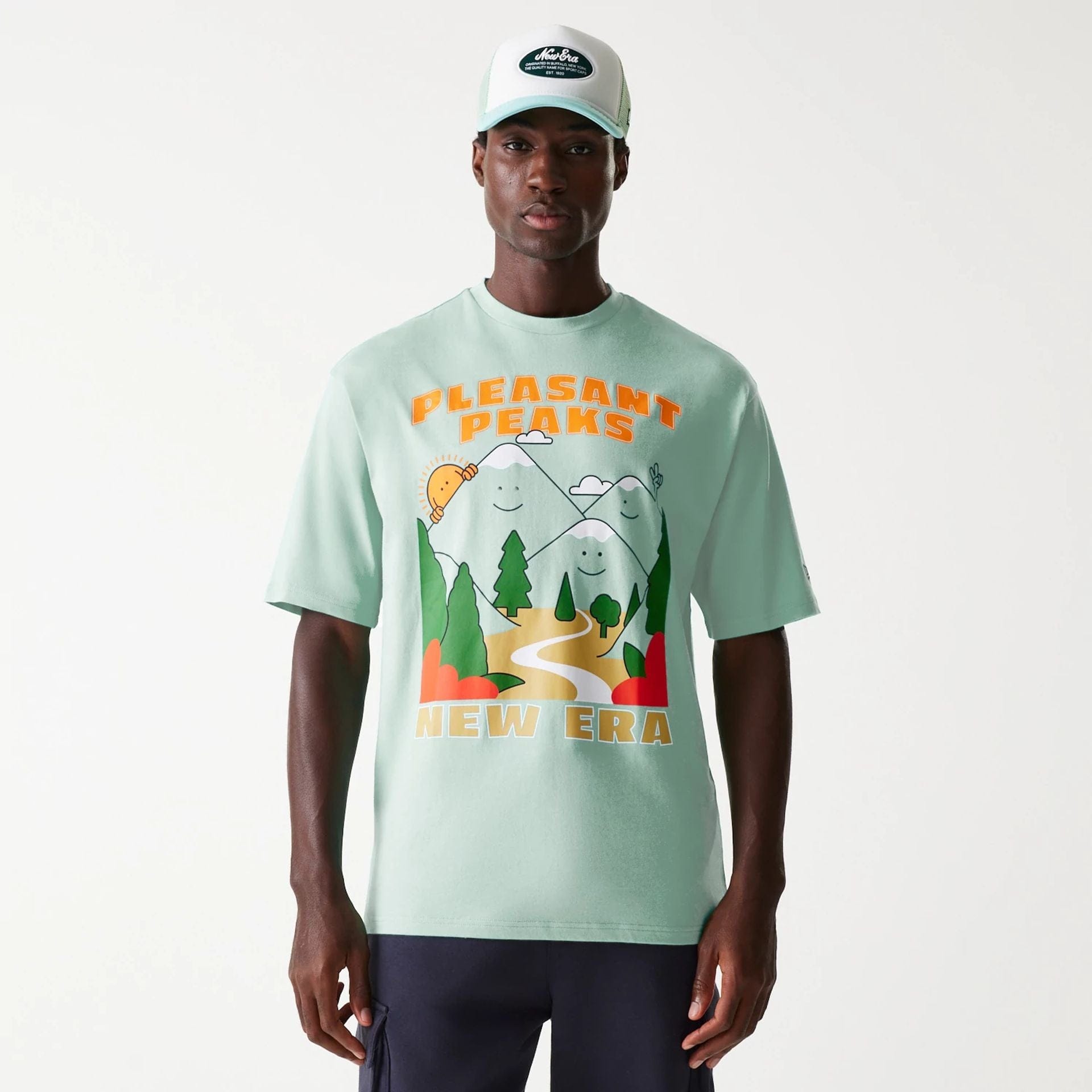 The Male model is wearing New Era Outdoor Graphic Pastel Green Oversized T-Shirt 1