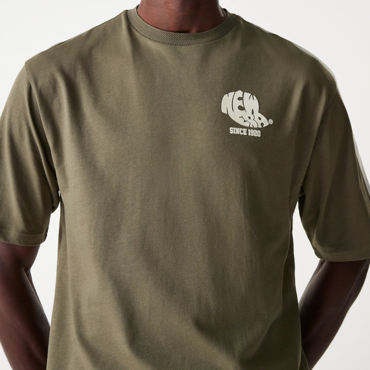 New Era Graphic Green Oversized T-Shirt, front view featuring a soft green fabric with a raised white New Era Since 1920 logo on the left chest, short sleeves and a classic crew neckline.