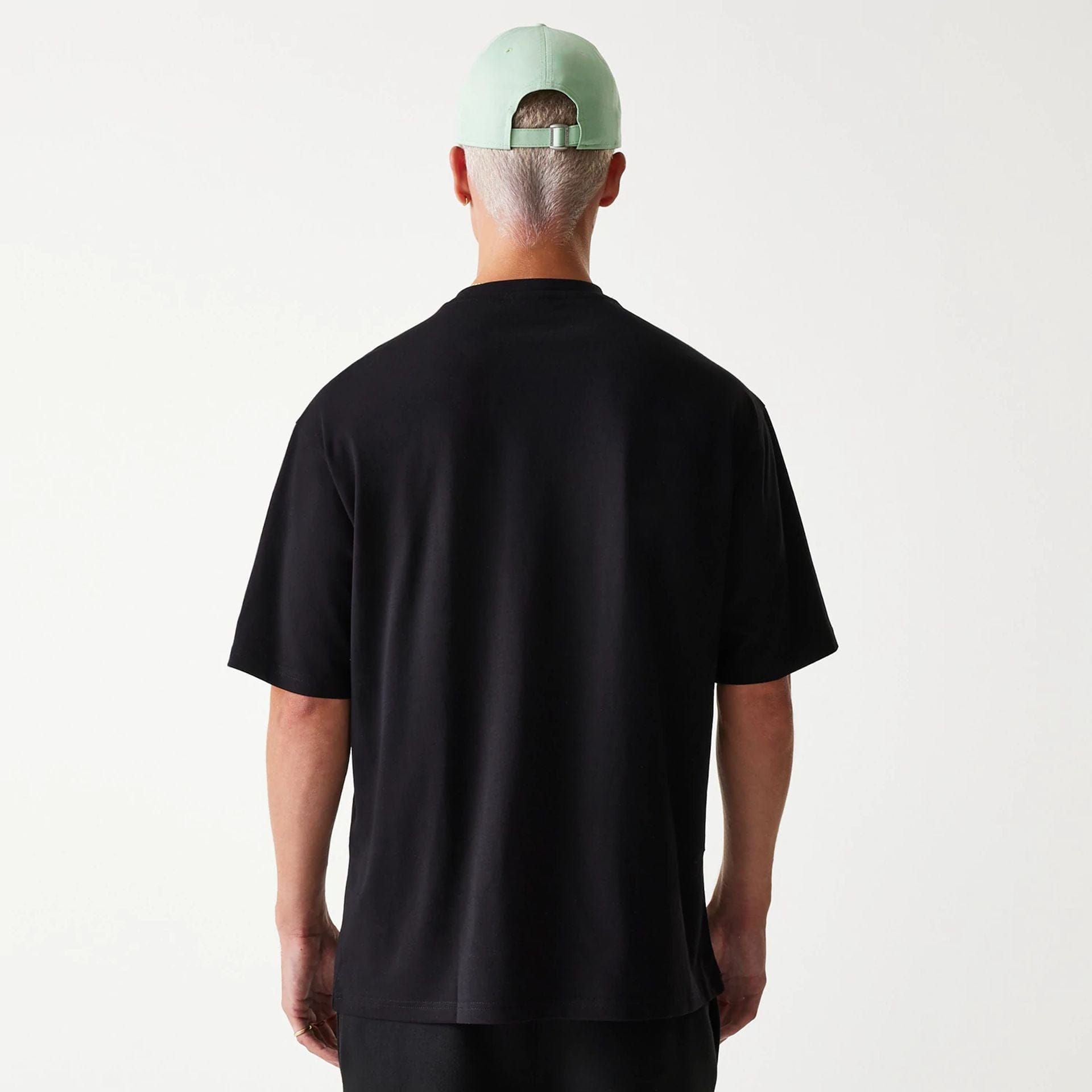 The Male model is wearing New Era Outdoor Graphic Black Oversized T-Shirt 2