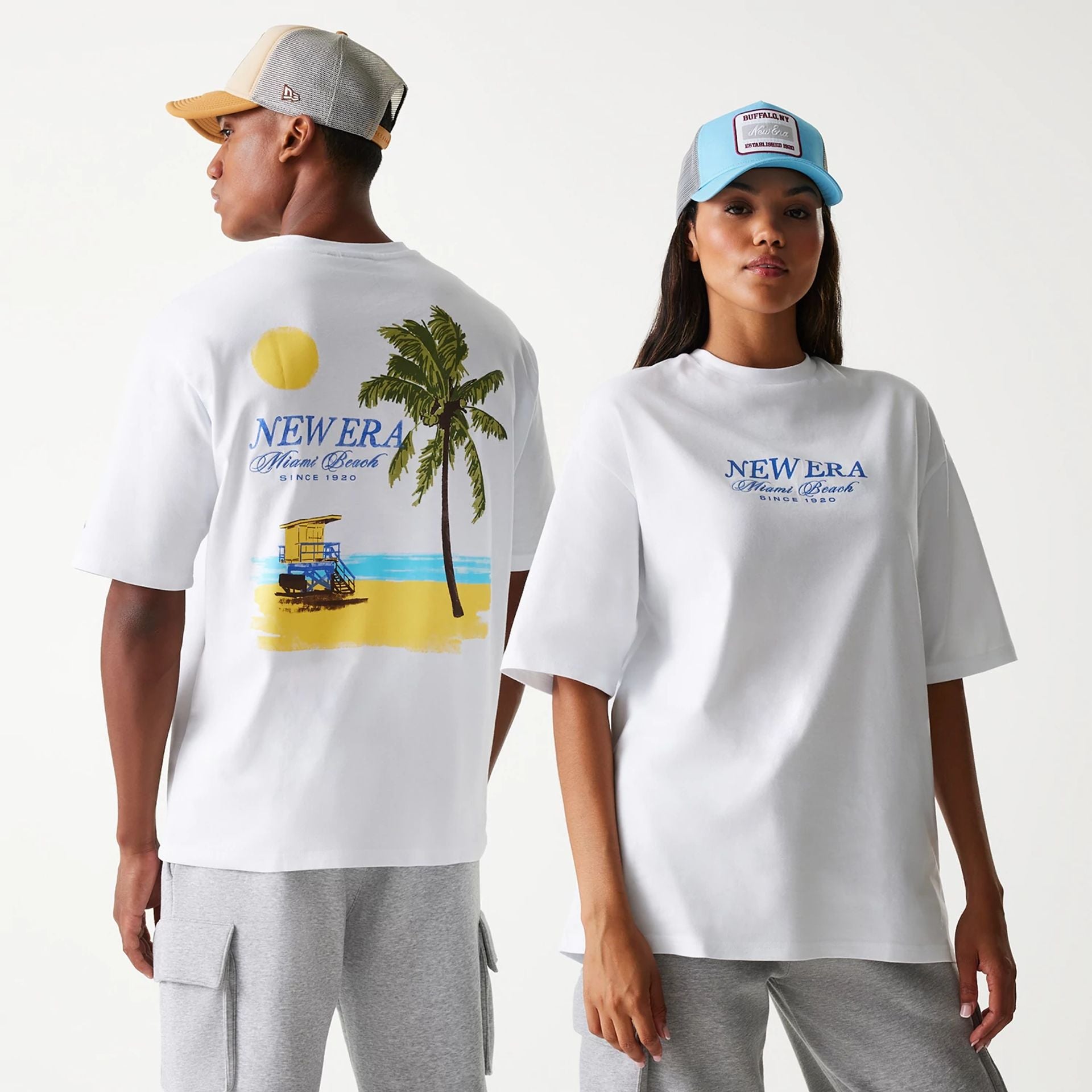 The Male model is wearing New Era Vacation Graphic White Oversized T-Shirt 1