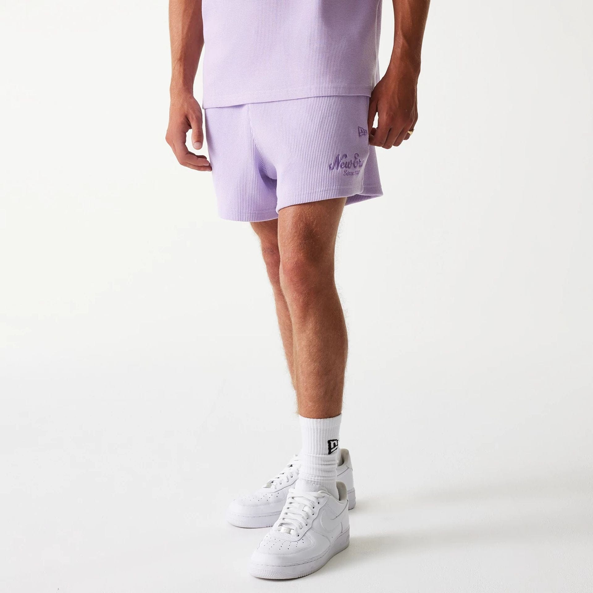 The Male model is wearing New Era Waffle Pastel Purple Shorts 1