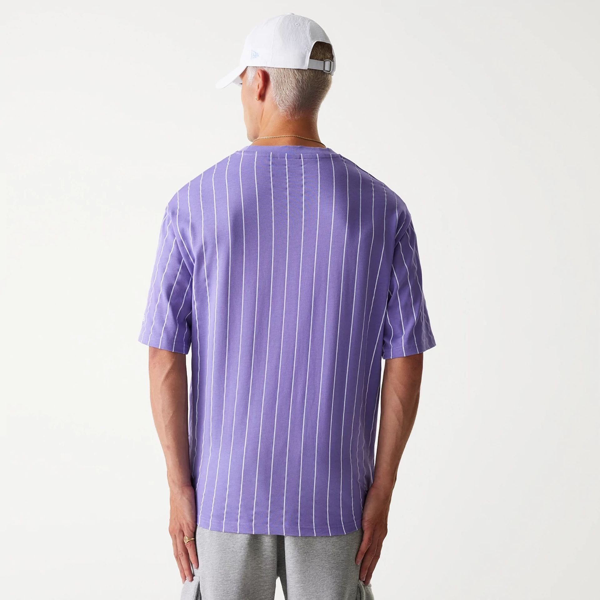 The Male model is wearing New Era Pinstripe Purple Oversized T-Shirt 2