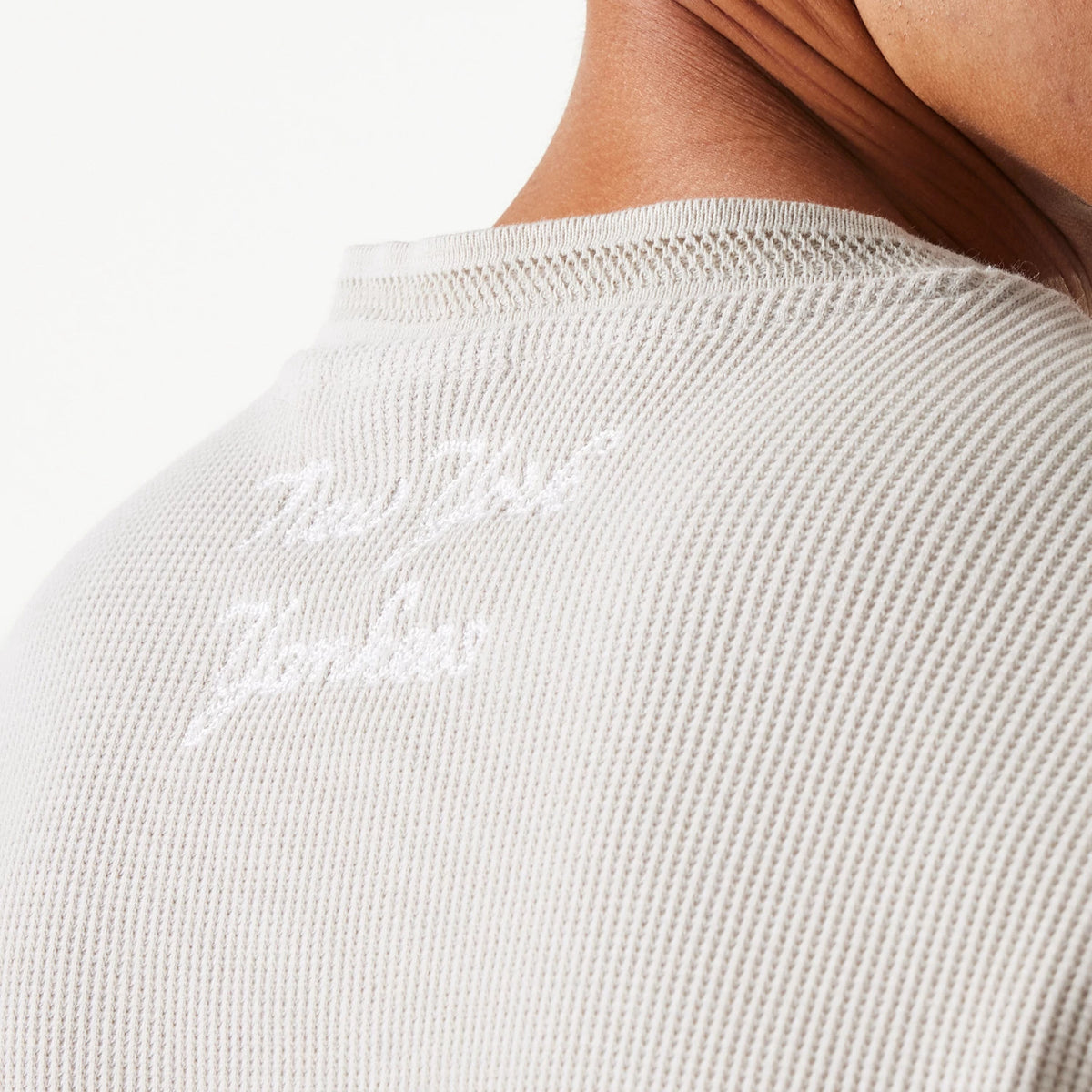 New Era New York Yankees MLB Waffle Cream Oversized Crew Neck Sweater, close-up showing the textured waffle pattern fabric and embroidered team lettering on the back near the collar.