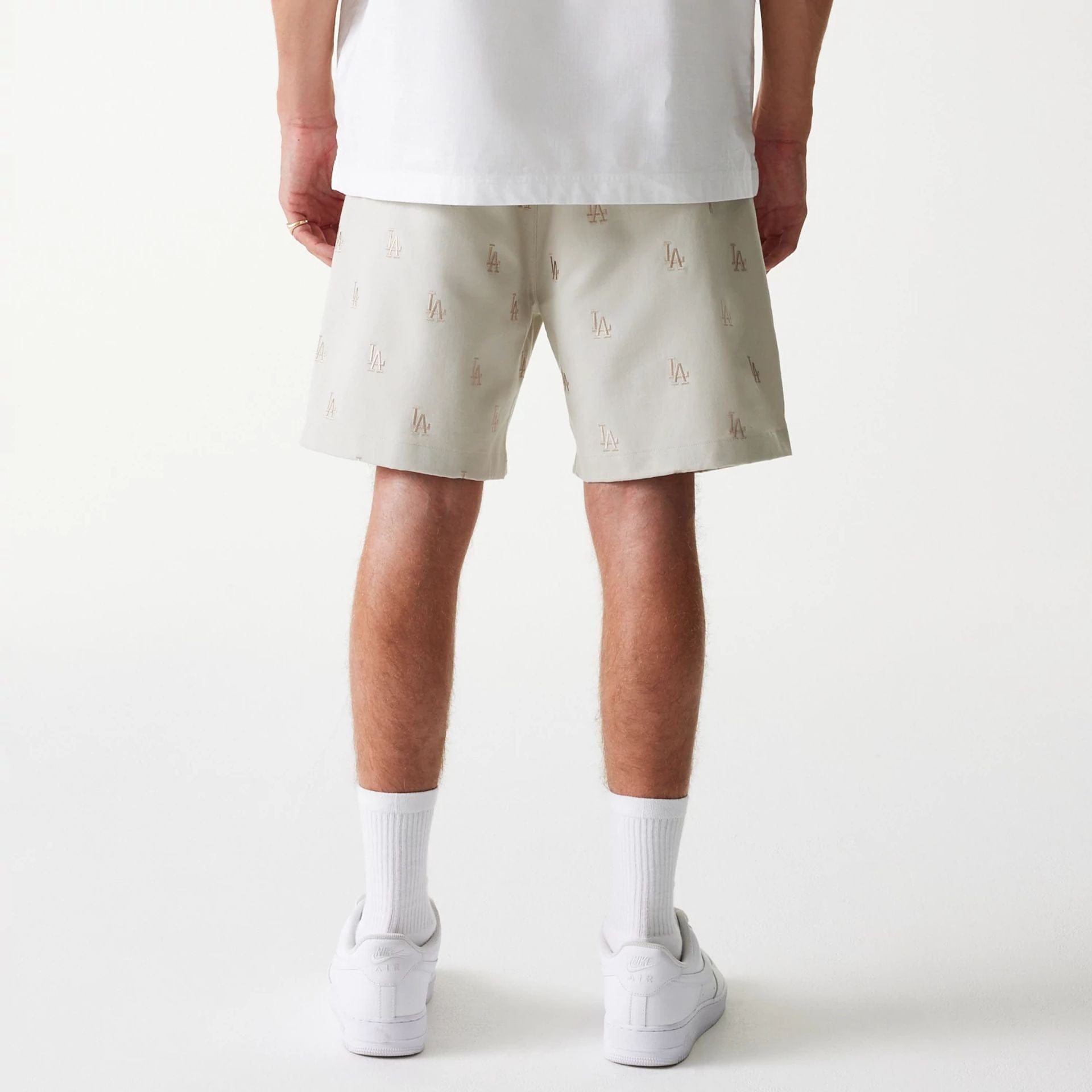 The Male model is wearing LA Dodgers MLB Monogram Cream Shorts 2