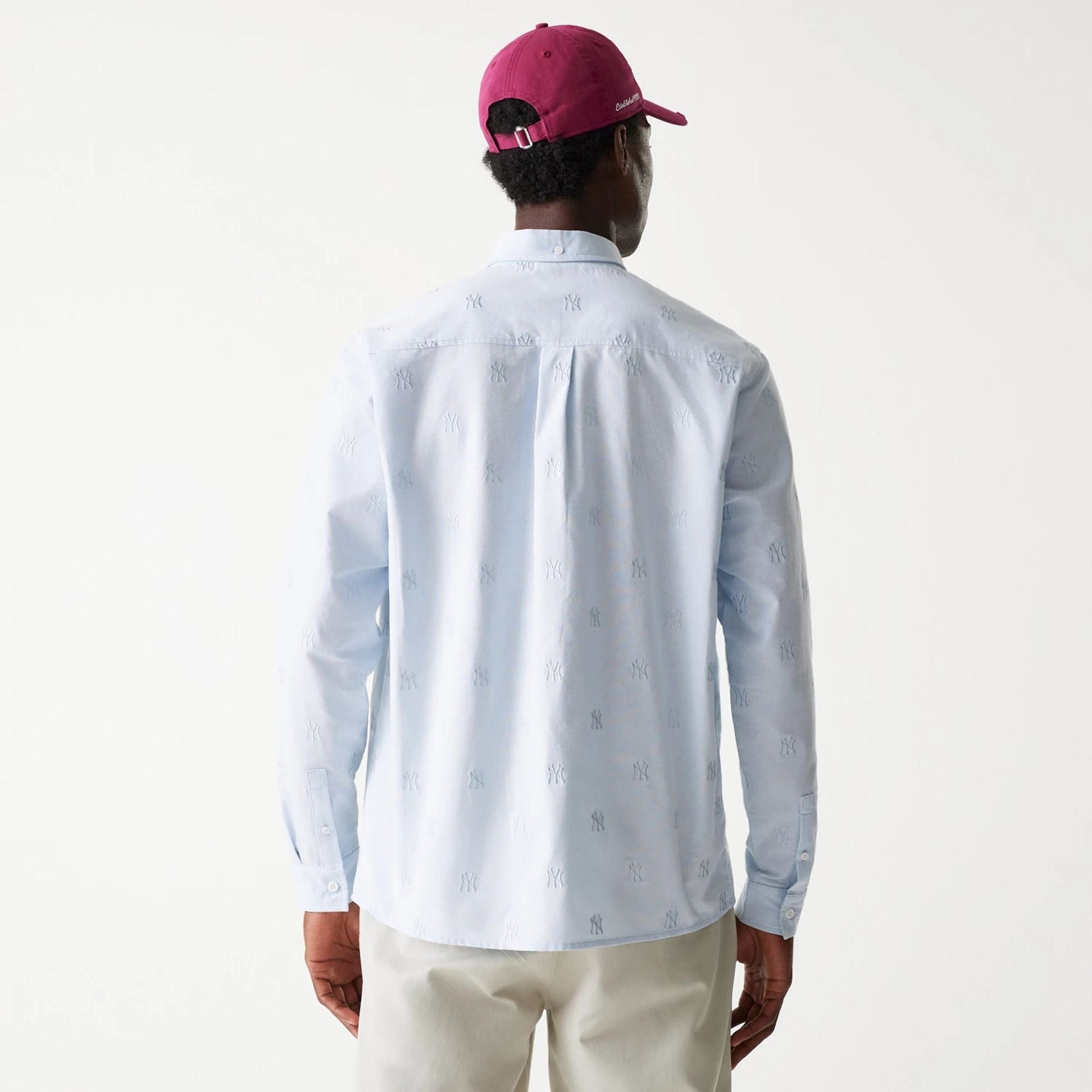 The Male model is wearing New York Yankees MLB Monogram Pastel Blue Long Sleeve Shirt 2