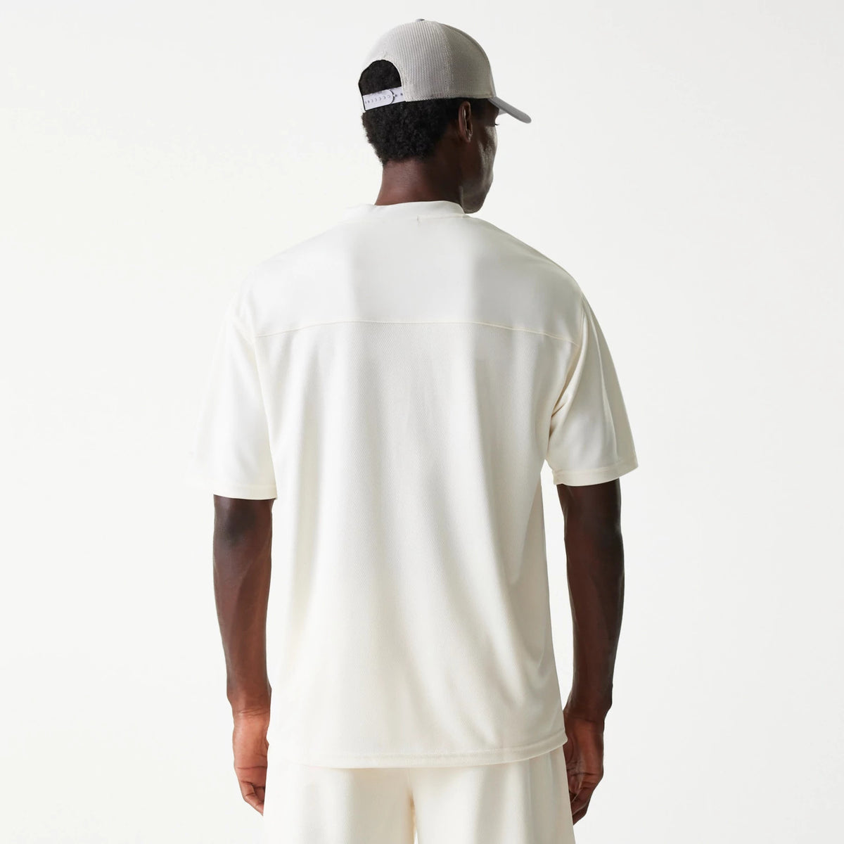 New Era LA Lakers NBA Tonal Open White Mesh Jersey, back view on a model with a grey cap, featuring a seamless yoke detail across the shoulders and a relaxed fit for comfortable wear.