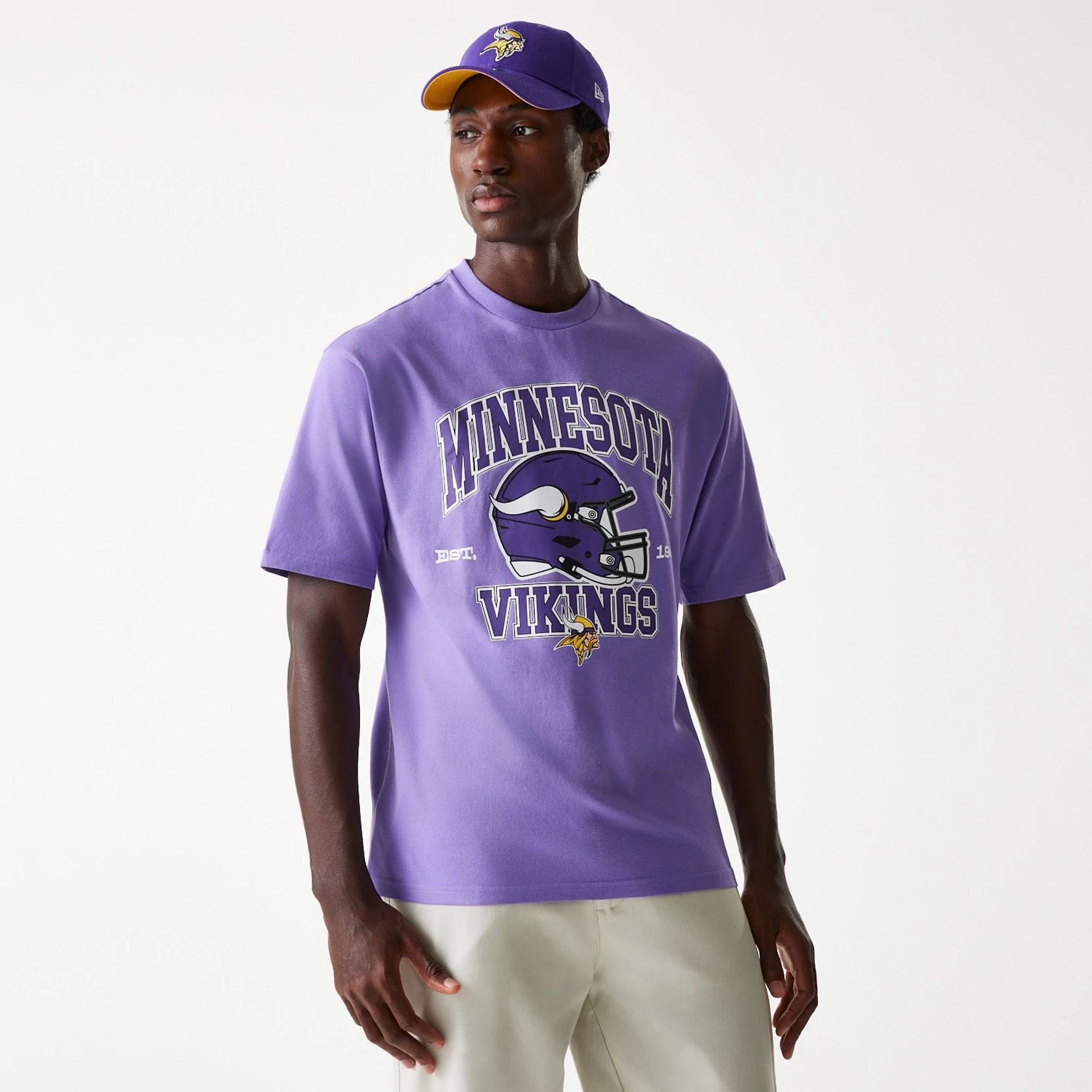 The Male model is wearing Minnesota Vikings NFL Helmet Purple Oversized T-Shirt 1