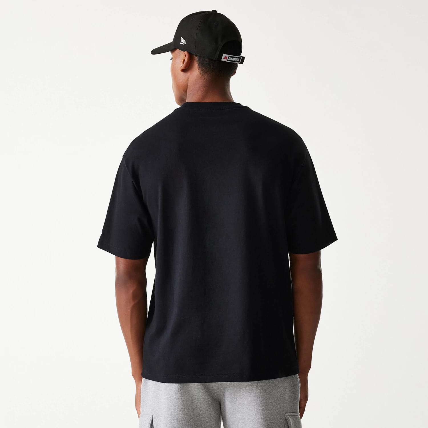 The Male model is wearing Las Vegas Raiders NFL Helmet Black Oversized T-Shirt 2