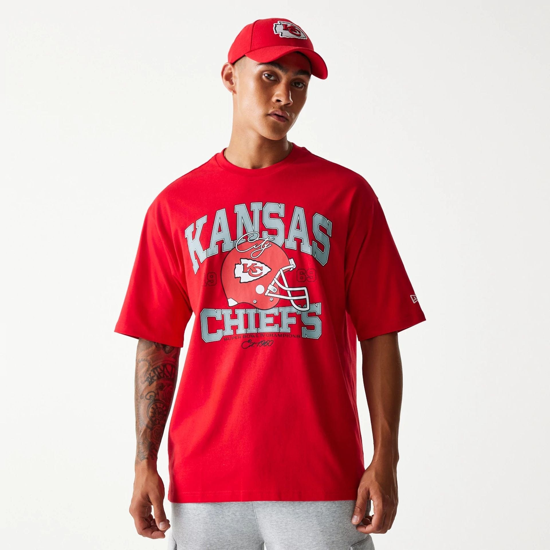 The Male model is wearing Kansas City Chiefs NFL Helmet Red Oversized T-Shirt 1