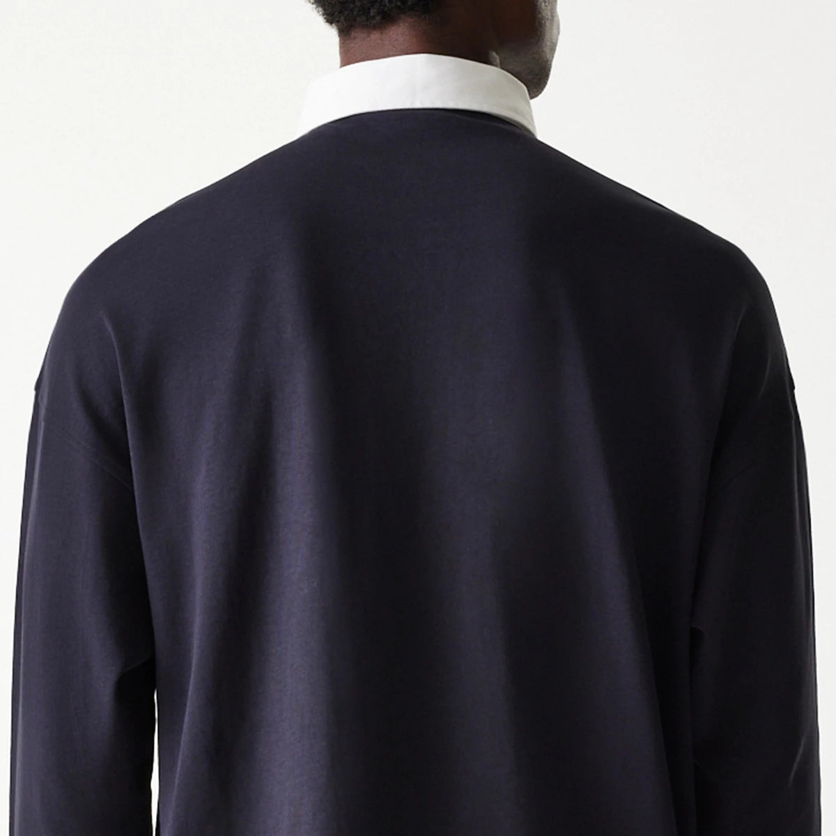 The Male model is wearing New Era Navy Oversized Rugby Shirt 7