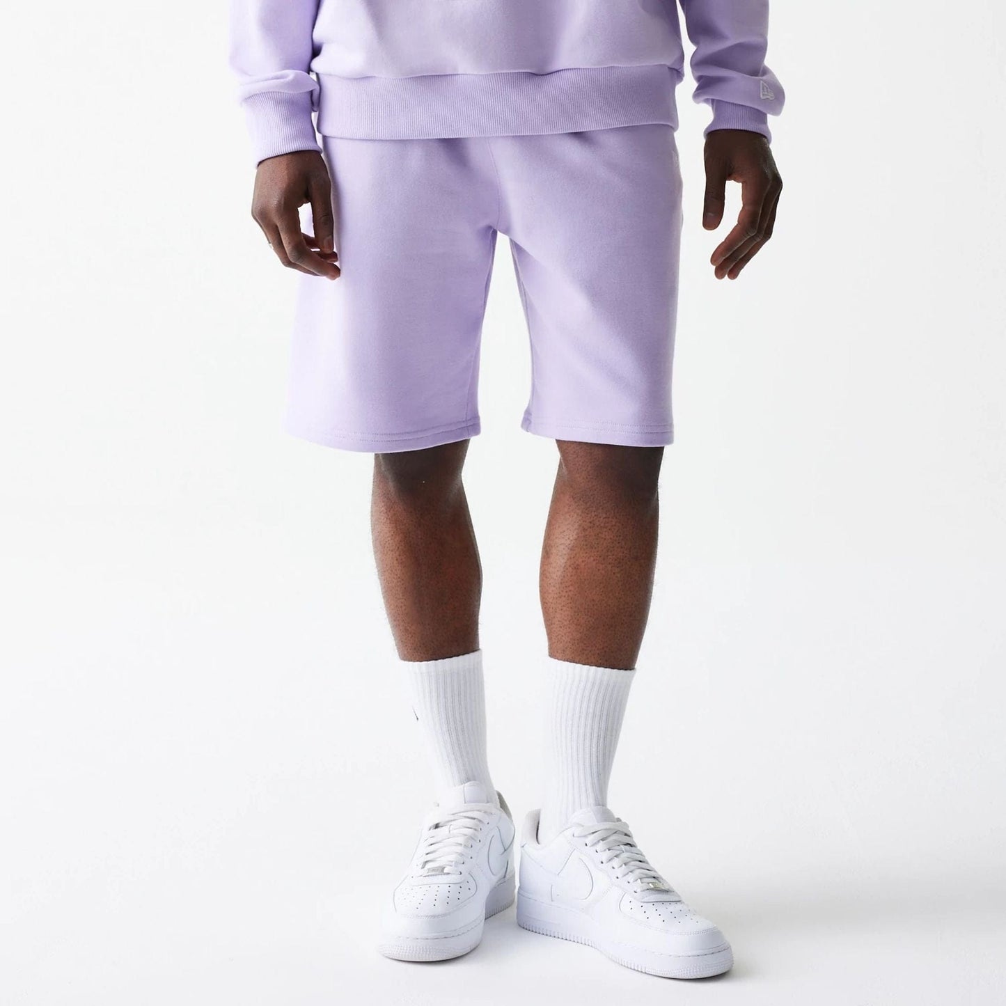 The Male model is wearing New Era Pastel Purple Oversized One Panel Shorts 8