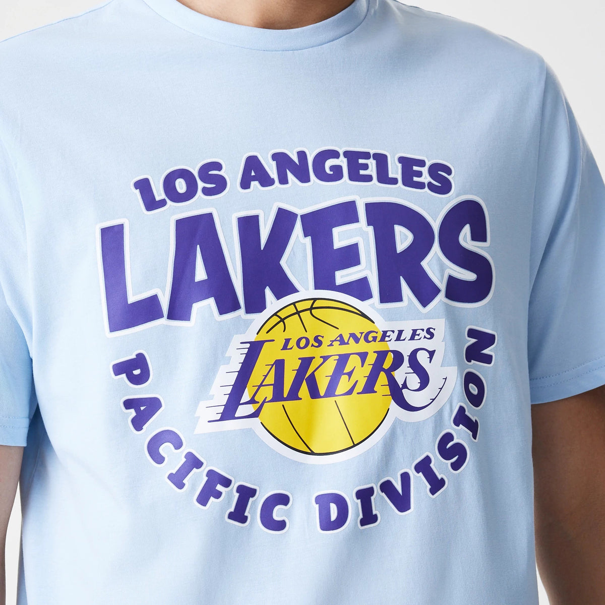New Era LA Lakers NBA Bubble Wordmark Pastel Blue T-Shirt, front view showing a large purple and yellow logo with Los Angeles Lakers text over a basketball graphic on the chest, on a light blue fabric.