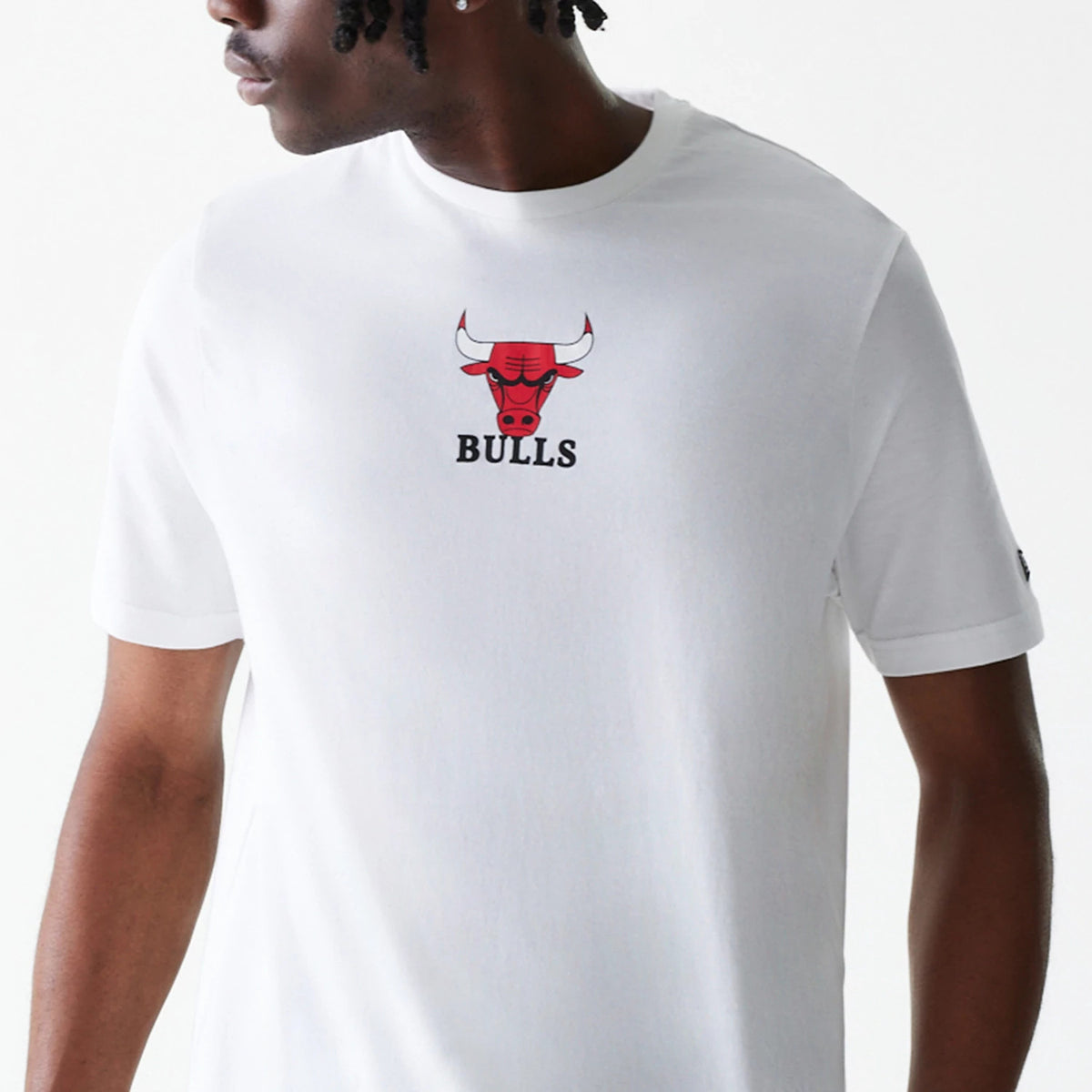 New Era Chicago Bulls NBA Logo White T-Shirt, front view showing the central red and black Bulls logo with debossed features, the word Bulls beneath it, on a plain white fabric with short sleeves.