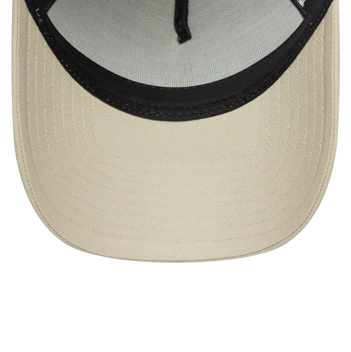 New York Yankees MLB League Essential Light Beige New Era 9FORTY E-Frame Trucker Adjustable Cap, inside view showing black sweatband contrast and light beige undervisor with crisp stitching detail.