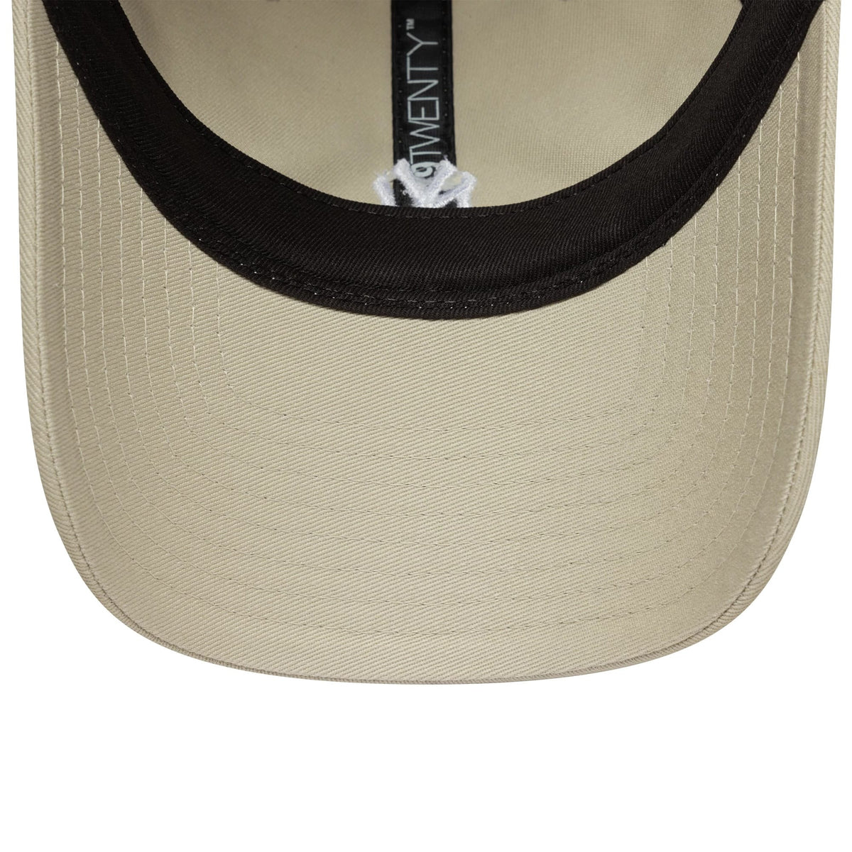 New York Yankees MLB Mini Logo Cream New Era 9TWENTY Adjustable Cap, inside view showing cream undervisor fabric with black taping running across, featuring a black 9TWENTY size sticker on the underside of the visor.