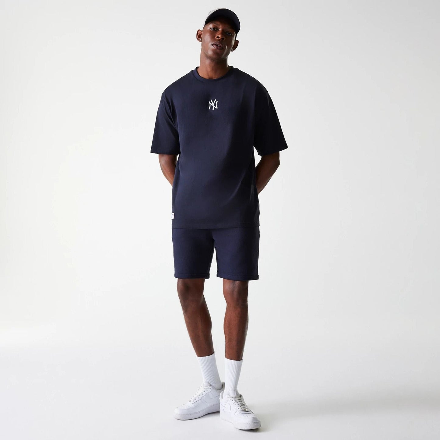 The Male model is wearing New York Yankees MLB League Essential Navy Shorts 8