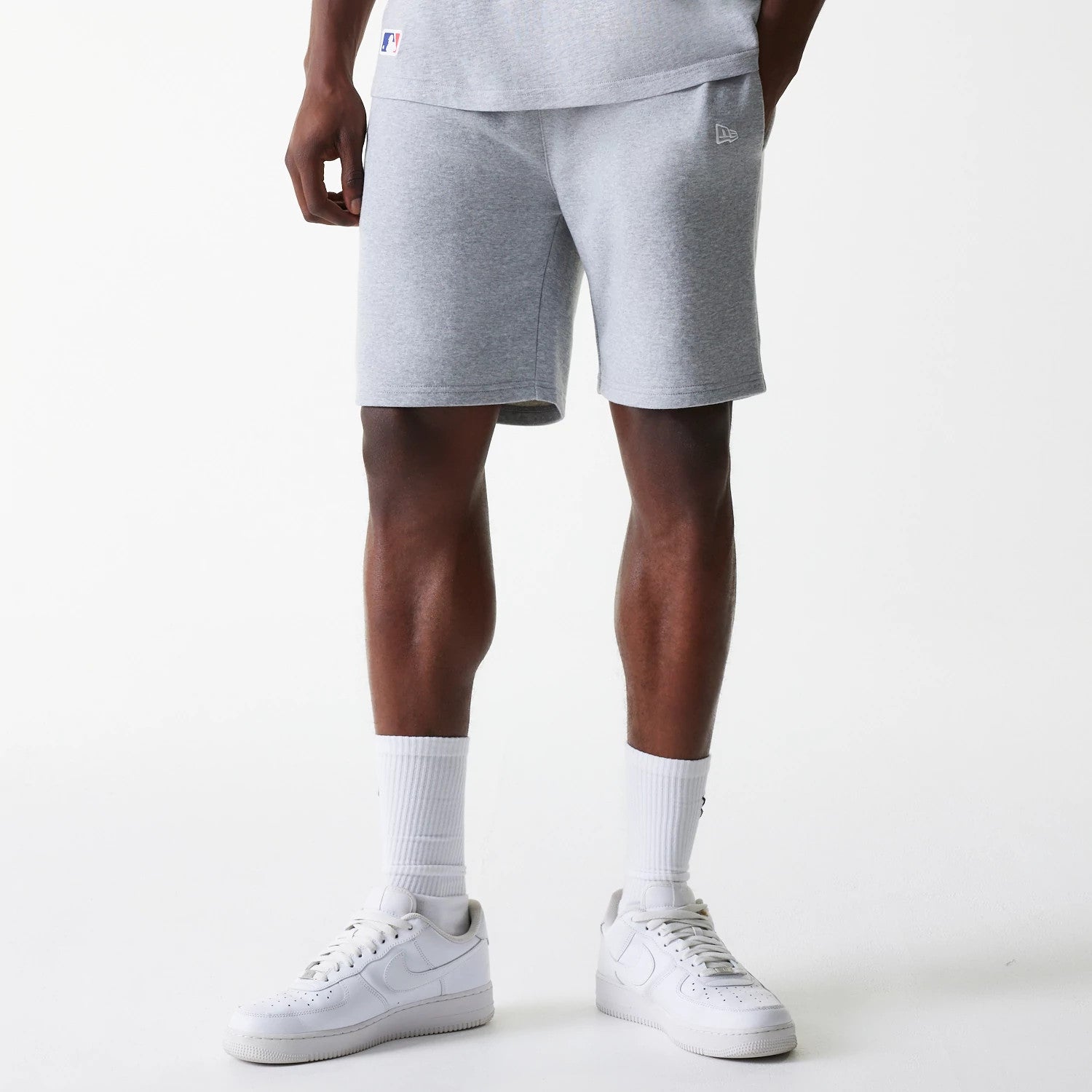 The Male model is wearing New York Yankees MLB League Essential Grey Shorts 1