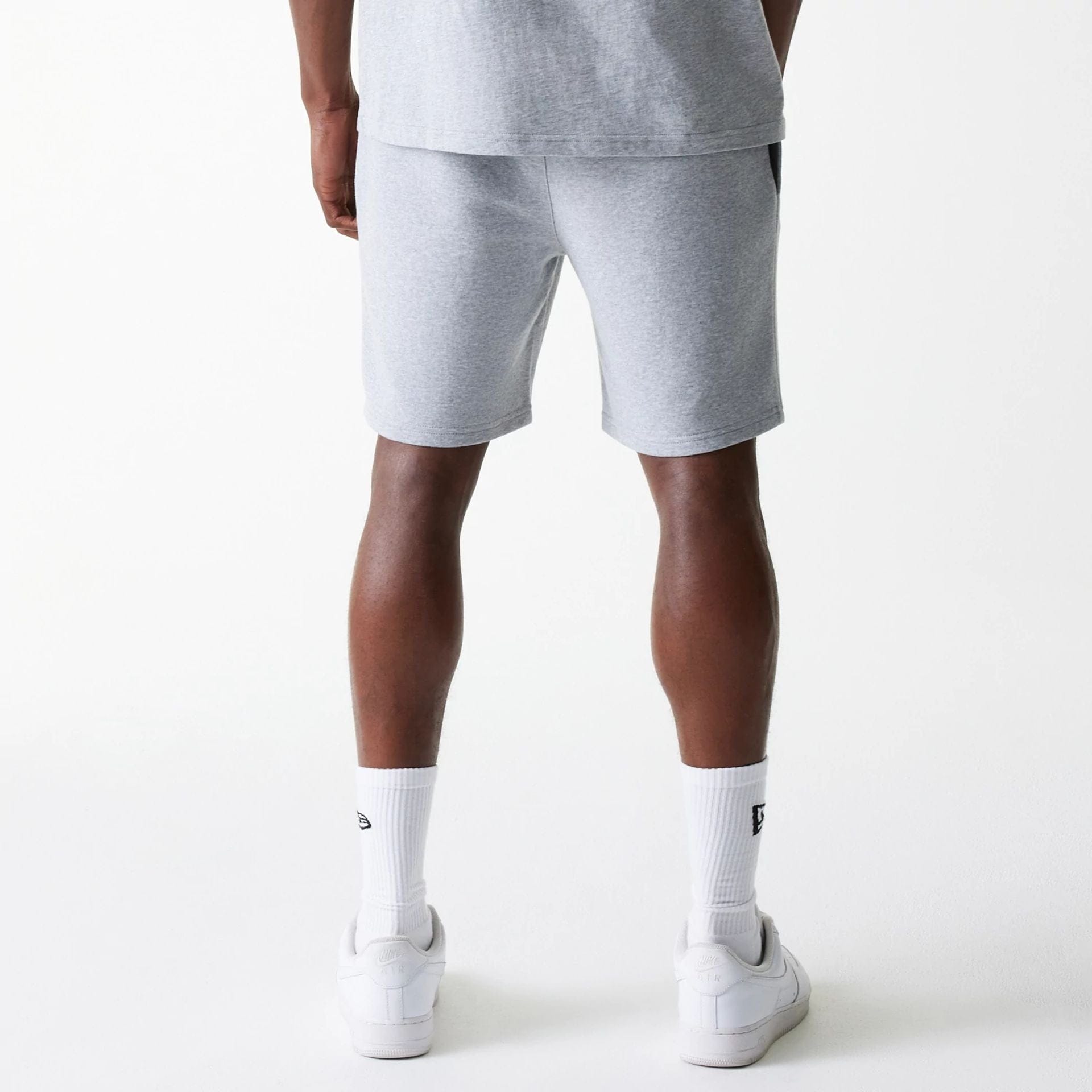 The Male model is wearing New York Yankees MLB League Essential Grey Shorts 2
