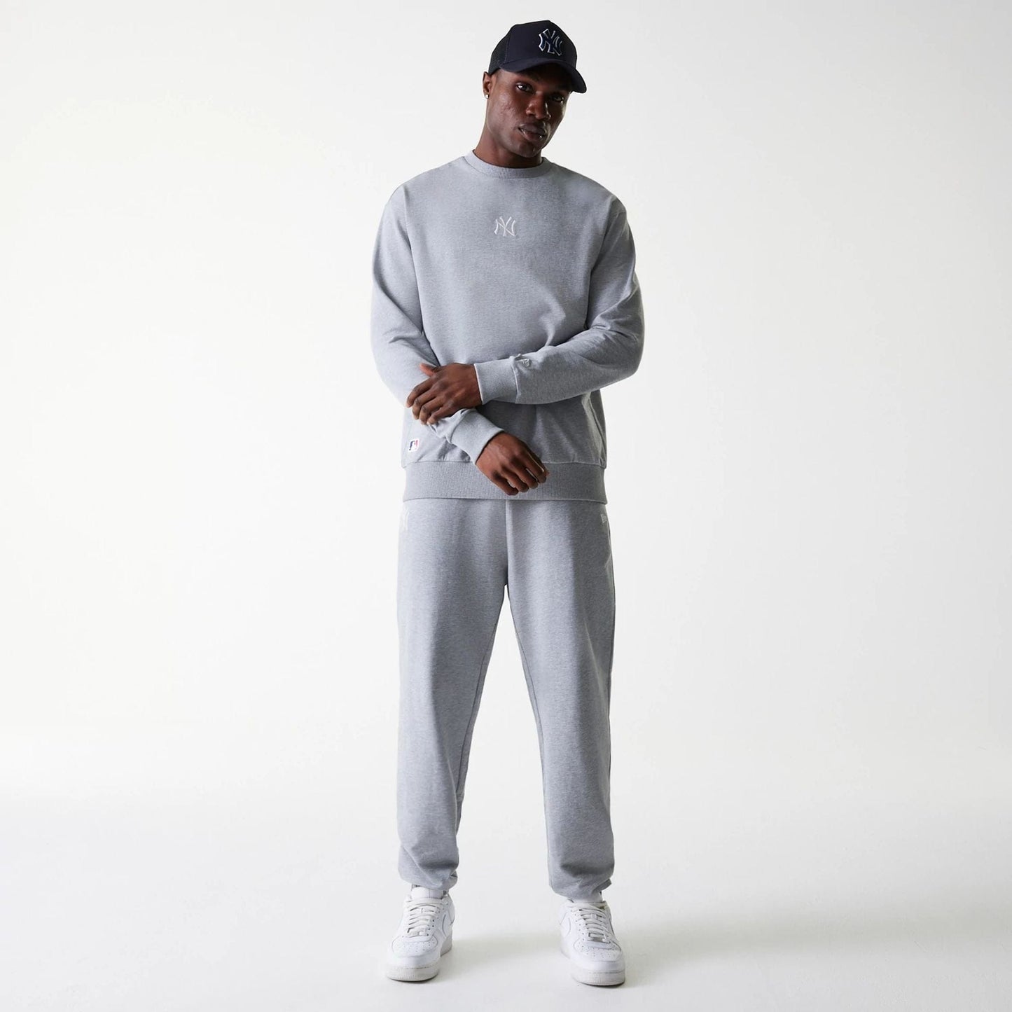 The Male model is wearing New York Yankees MLB League Essential Grey Crew Neck Sweater 8