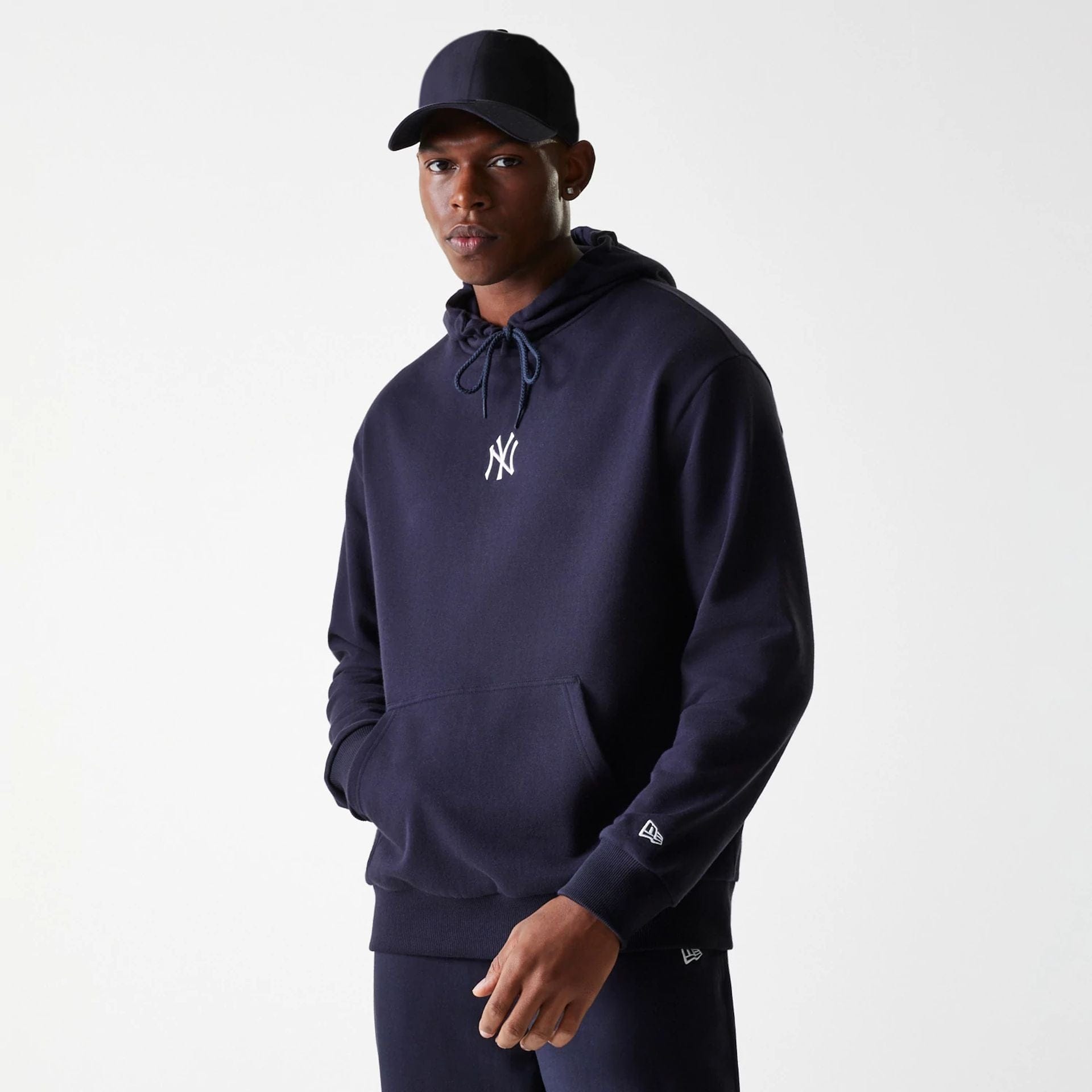 The Male model is wearing New York Yankees MLB League Essential Midi Navy Oversized Pullover Hoodie 1
