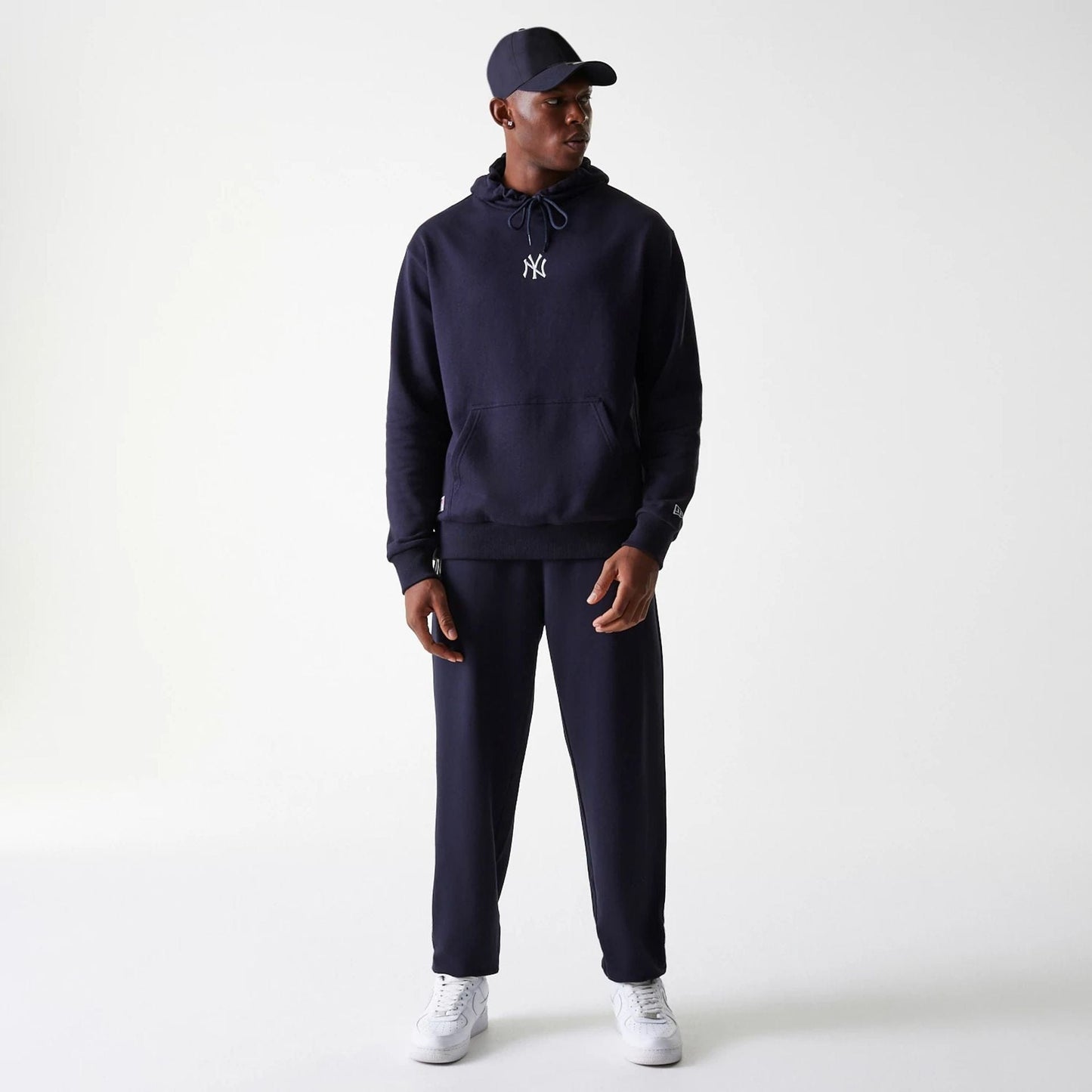 The Male model is wearing New York Yankees MLB League Essential Midi Navy Oversized Pullover Hoodie 8