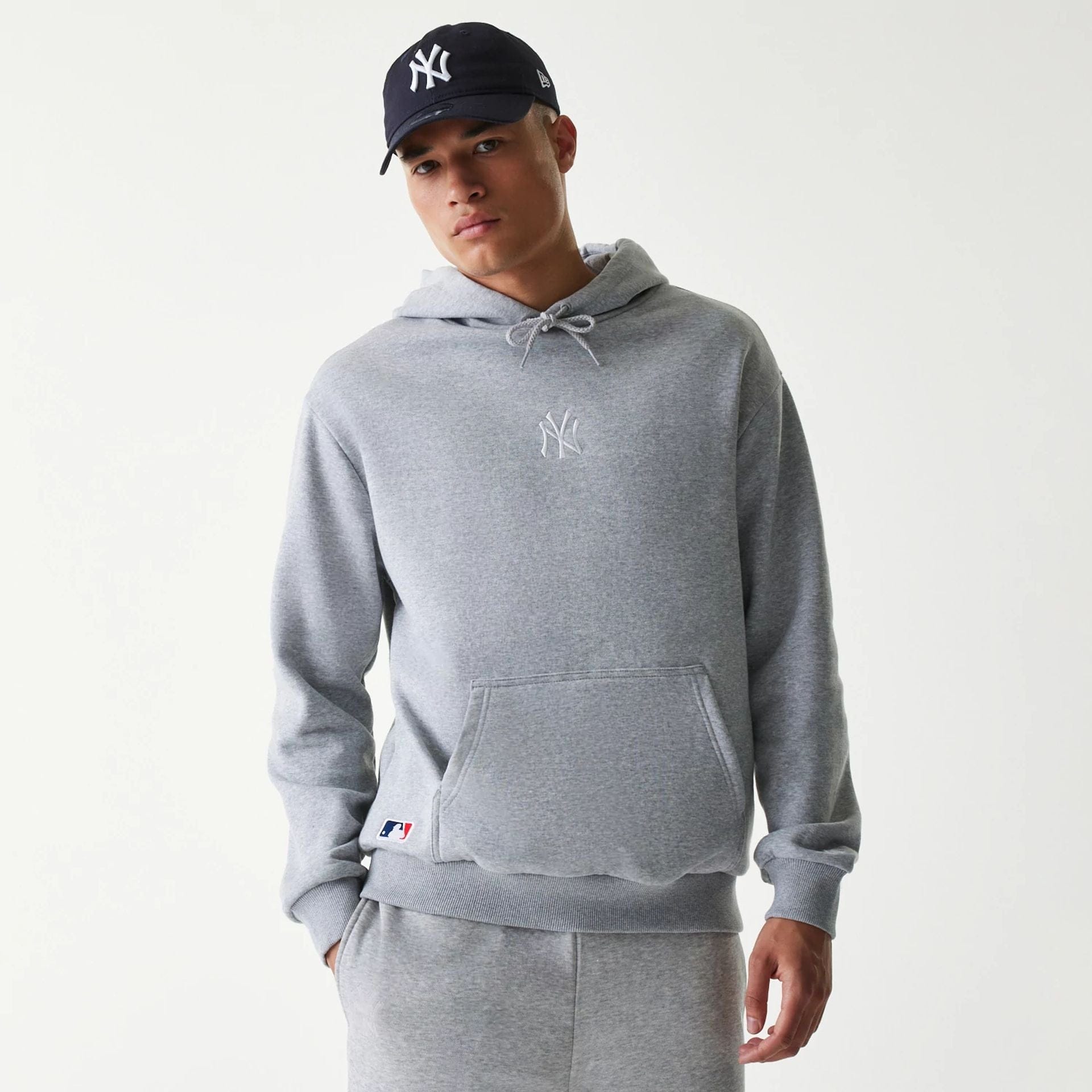 The Male model is wearing New York Yankees MLB League Essential Grey Oversized Pullover Hoodie 1