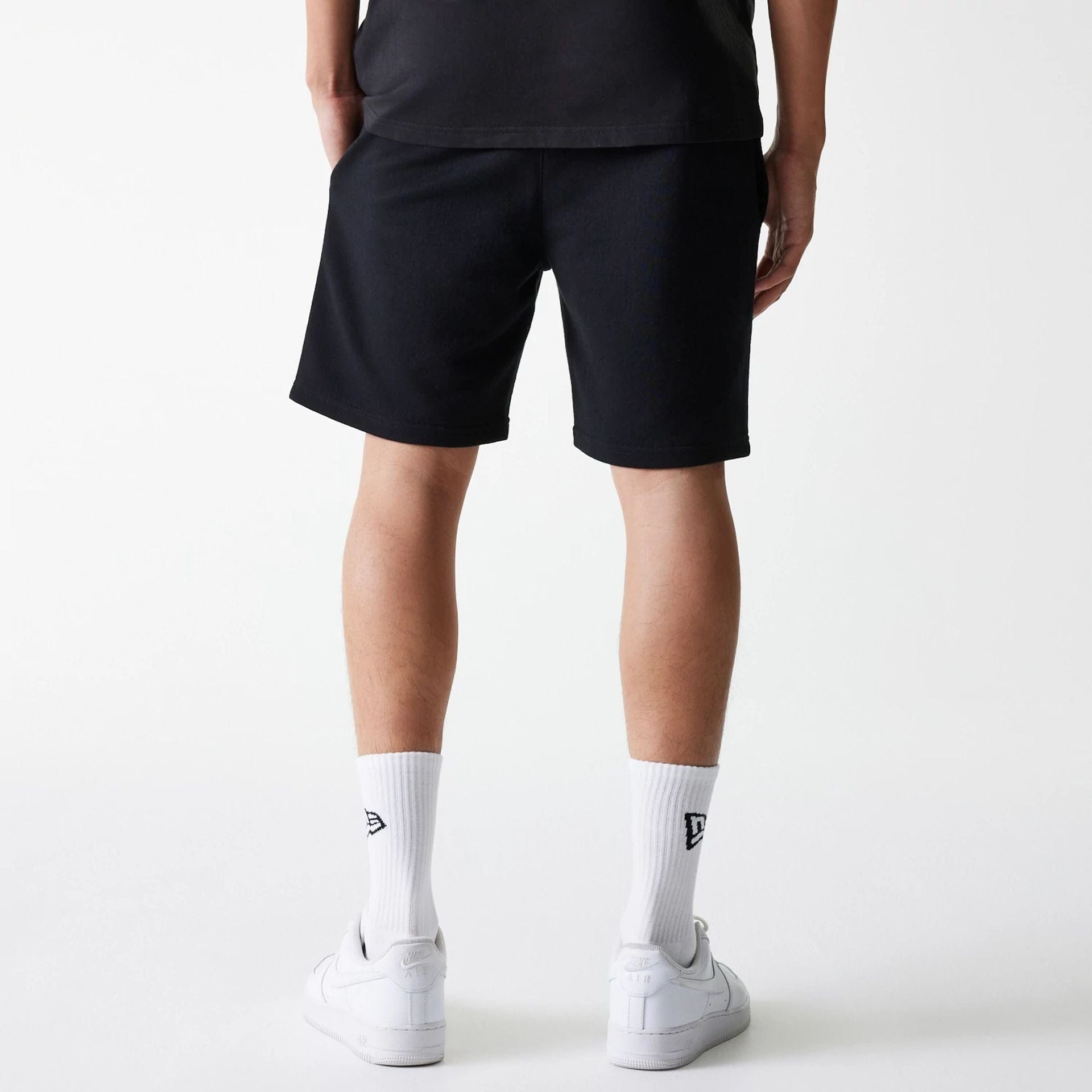 The Male model is wearing New York Yankees MLB League Essential Midi Black Shorts 2