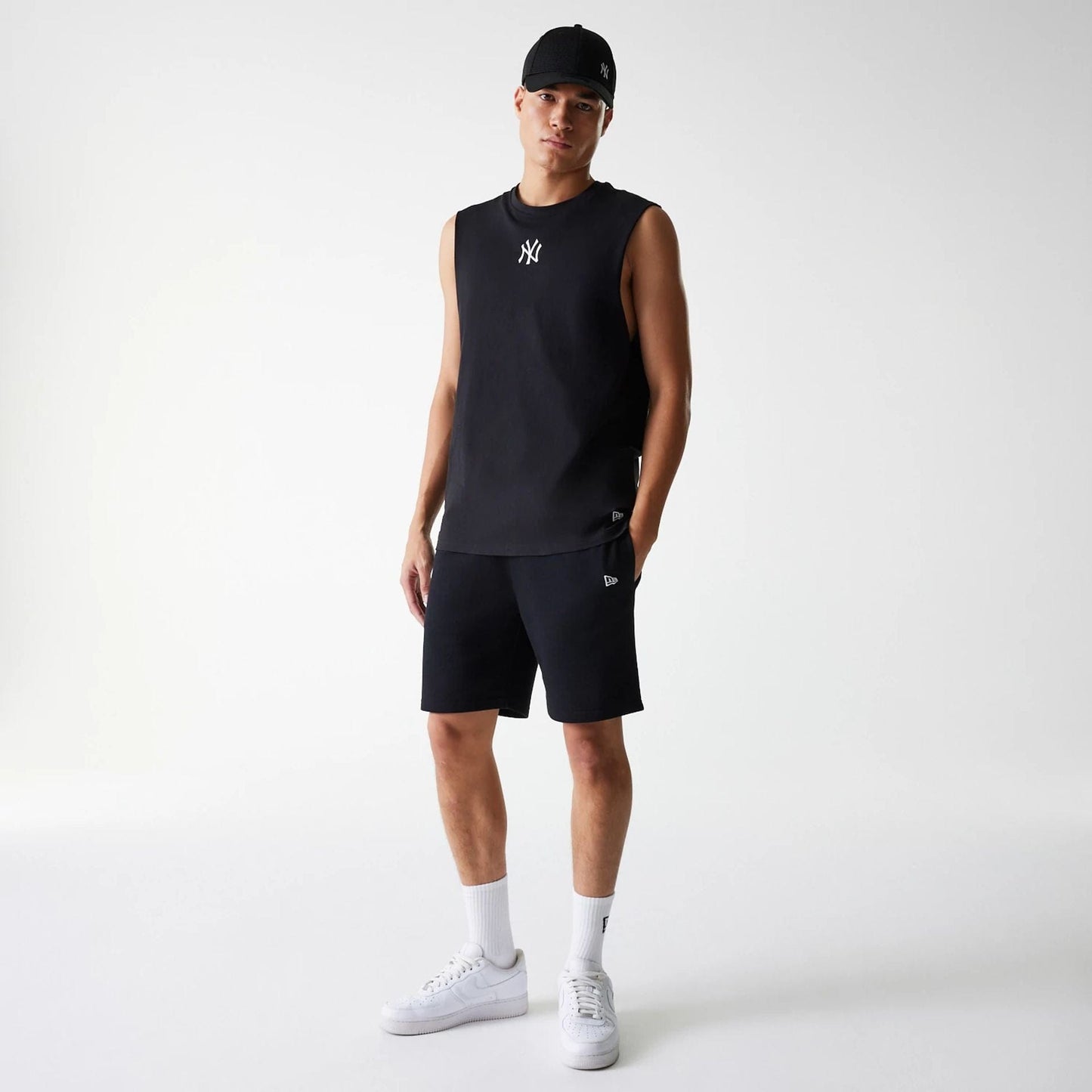 The Male model is wearing New York Yankees MLB League Essential Midi Black Shorts 8