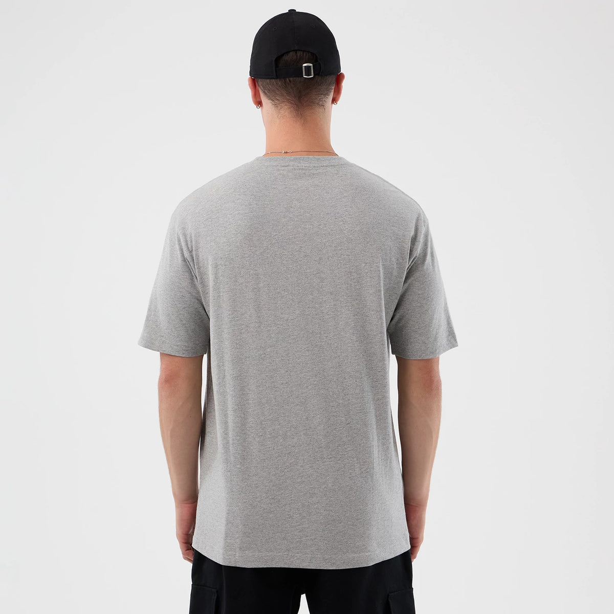 New Era Detroit Red Wings NHL Sport Classic Grey T-Shirt, rear view showing the plain grey back of the T-shirt with short sleeves extending from the shoulders, worn by a model wearing a black cap.
