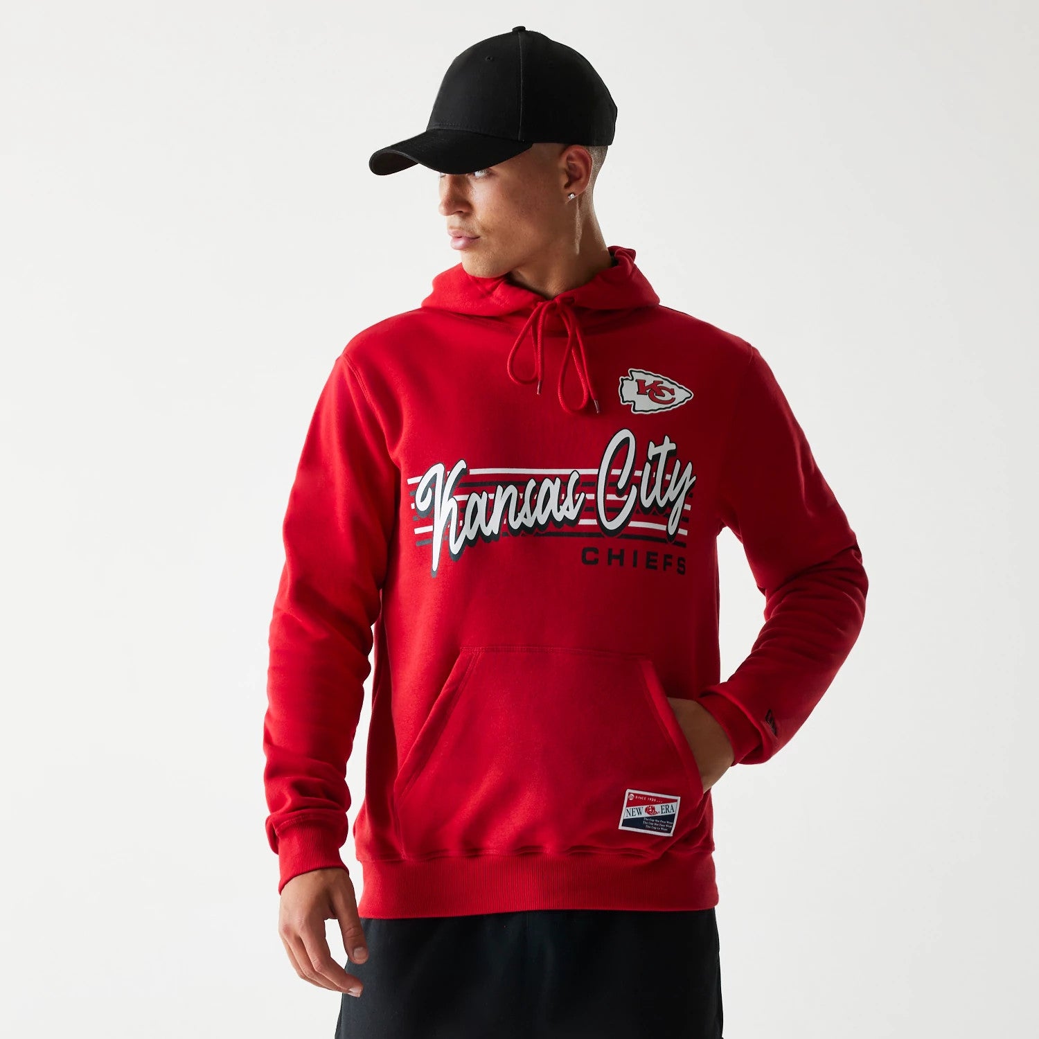 New Era Kansas City Chiefs NFL Throwback Red Pullover Hoodie, front view showing the Chiefs logo embroidered near the shoulder, Kansas City in large script across the chest, and a small raised New Era patch near the pocket.