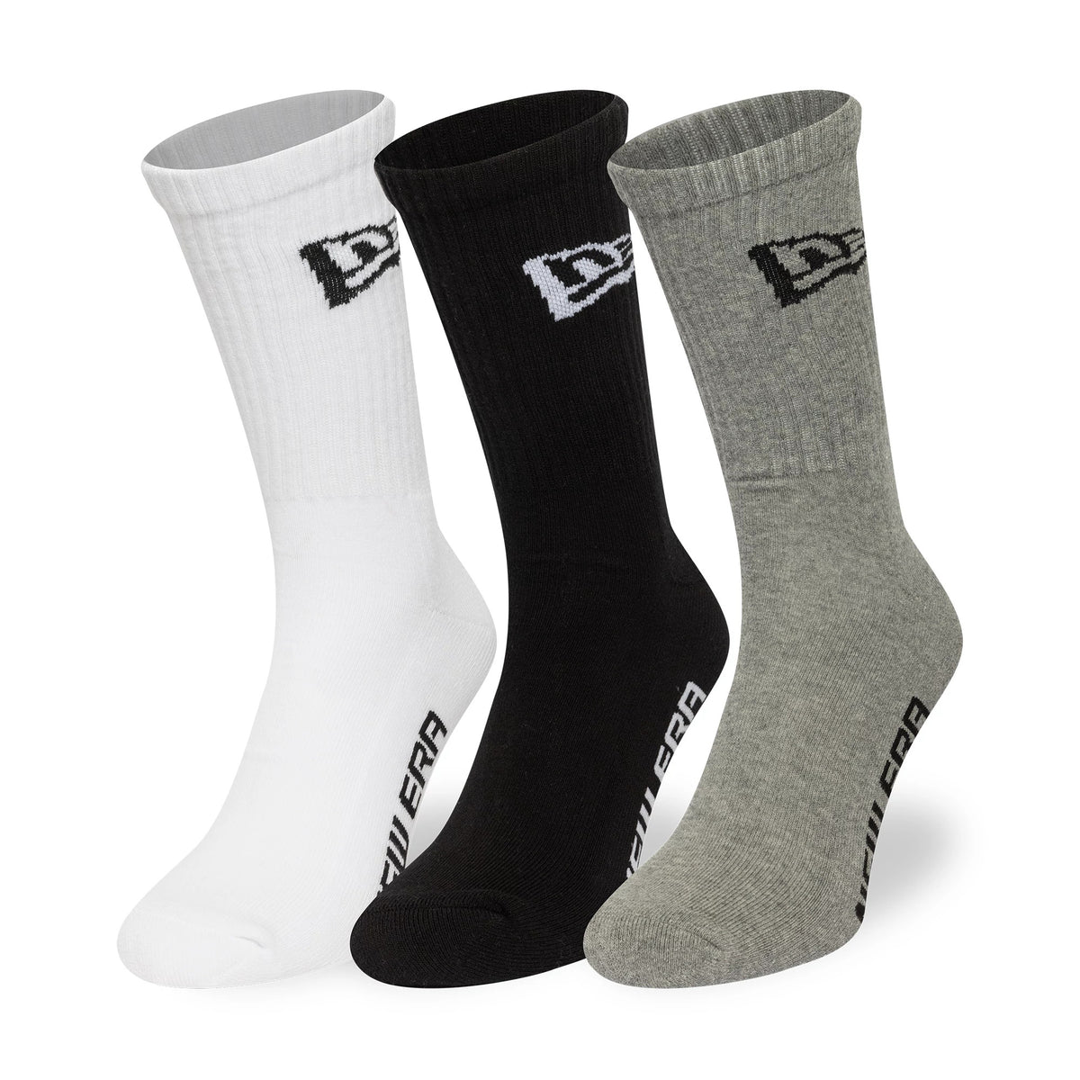 New Era Flag Multi Monochrome 3 Pack Crew Socks, front view showing three ribbed socks in white, black, and grey, each with an embroidered New Era logo on the side and New Era text along the foot.