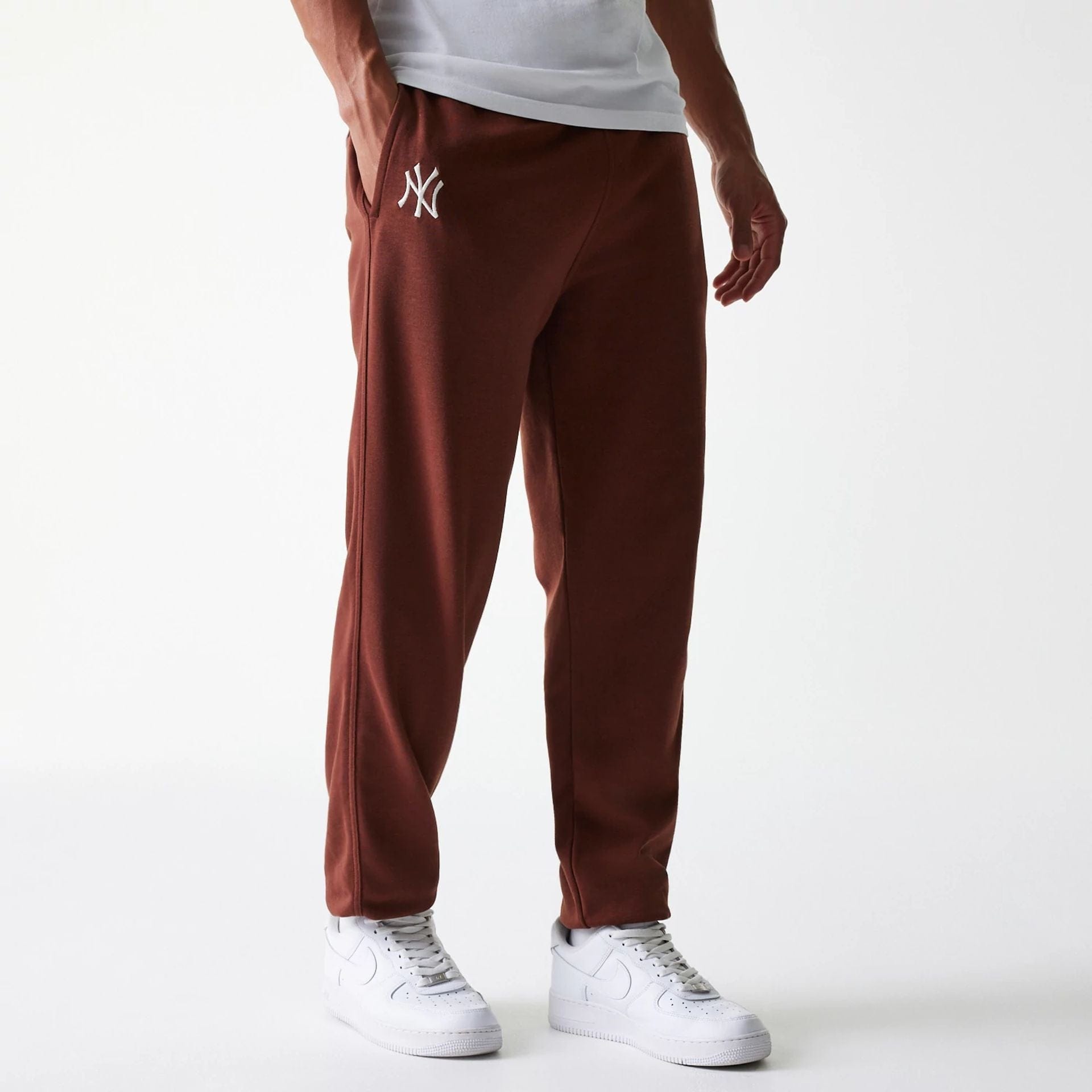 The Male model is wearing New York Yankees MLB Midi League Essential Brown Joggers 1